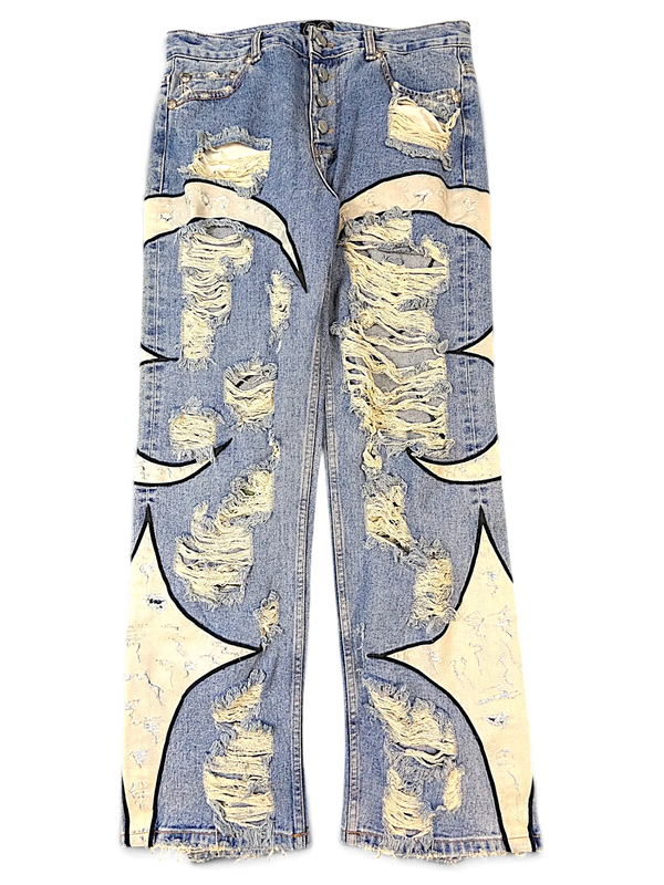 JAKE & IPI blue distressed denim jeans featuring cream-colored flame appliques and heavy ripped detailing.