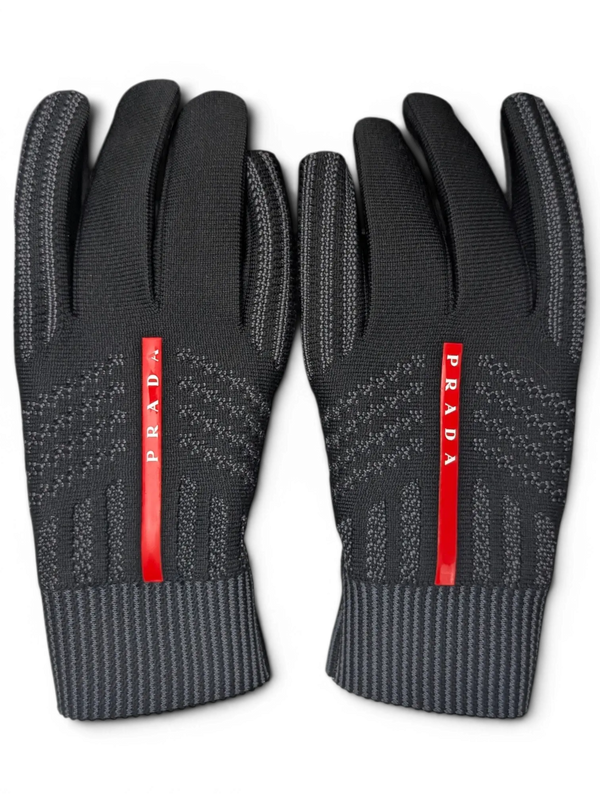 JAKE & IPI black Reusch for Prada knit gloves with red logo stripe and ribbed cuffs in a recycled cardboard box