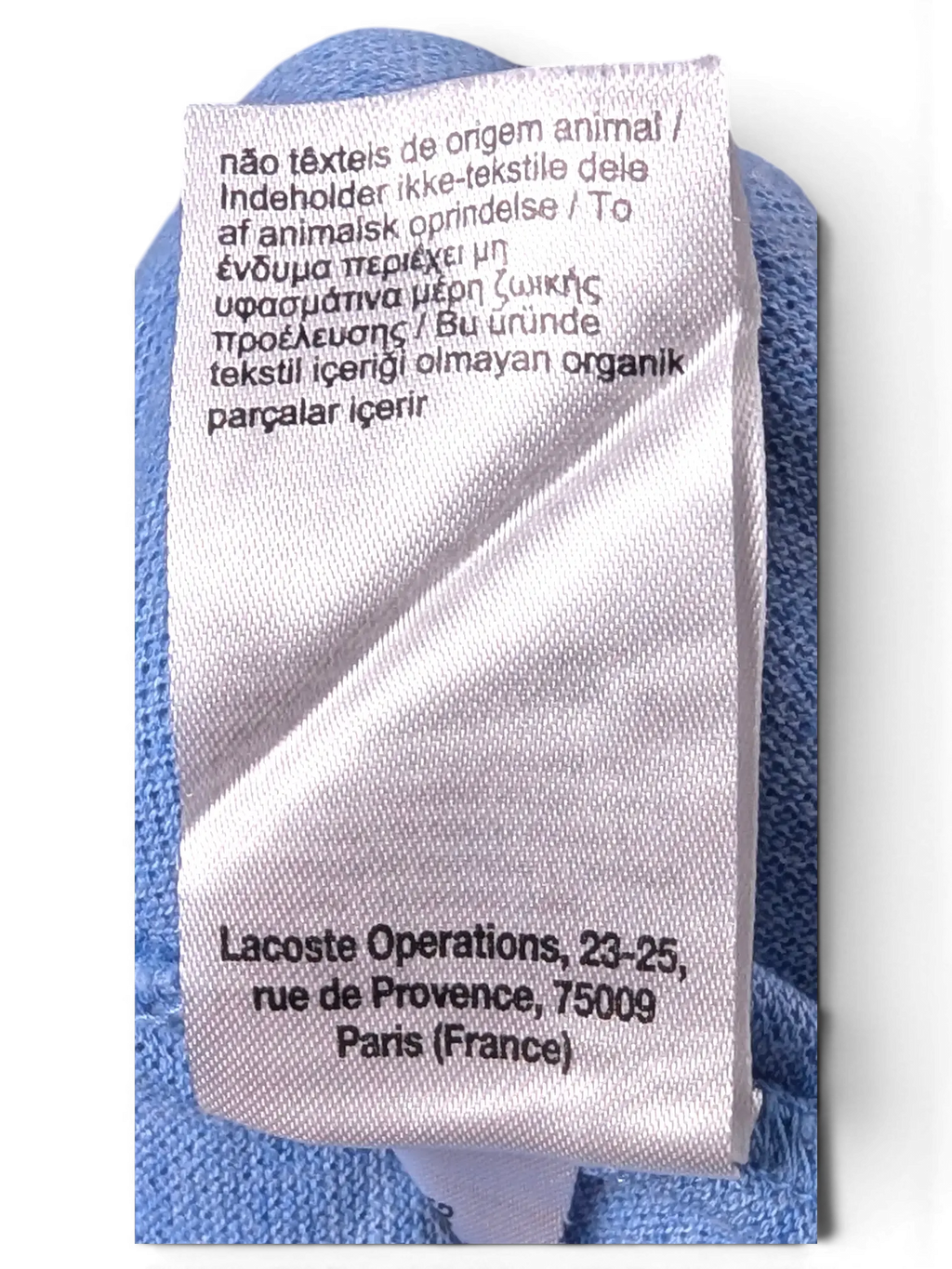 Interior brand and manufacturing label detail of Lacoste Light Blue Polo Shirt