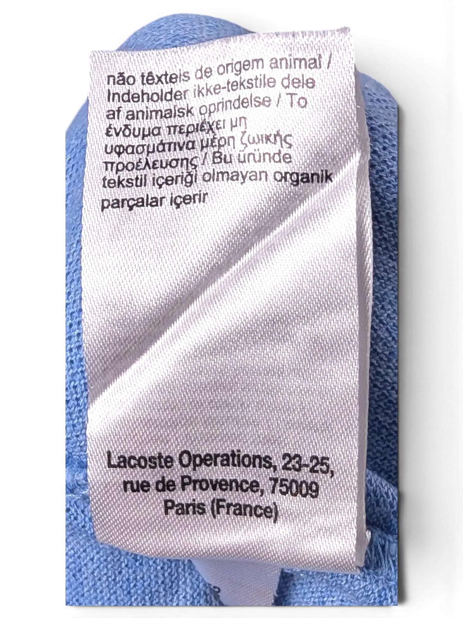 Interior brand and manufacturing label detail of Lacoste Light Blue Polo Shirt