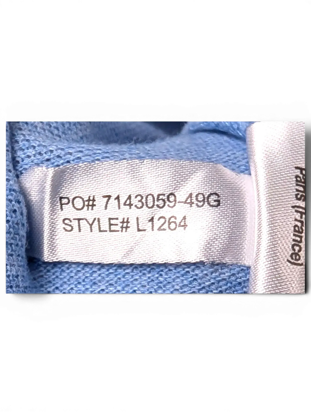 Interior care label and fabric detail of Lacoste Light Blue Polo Shirt
