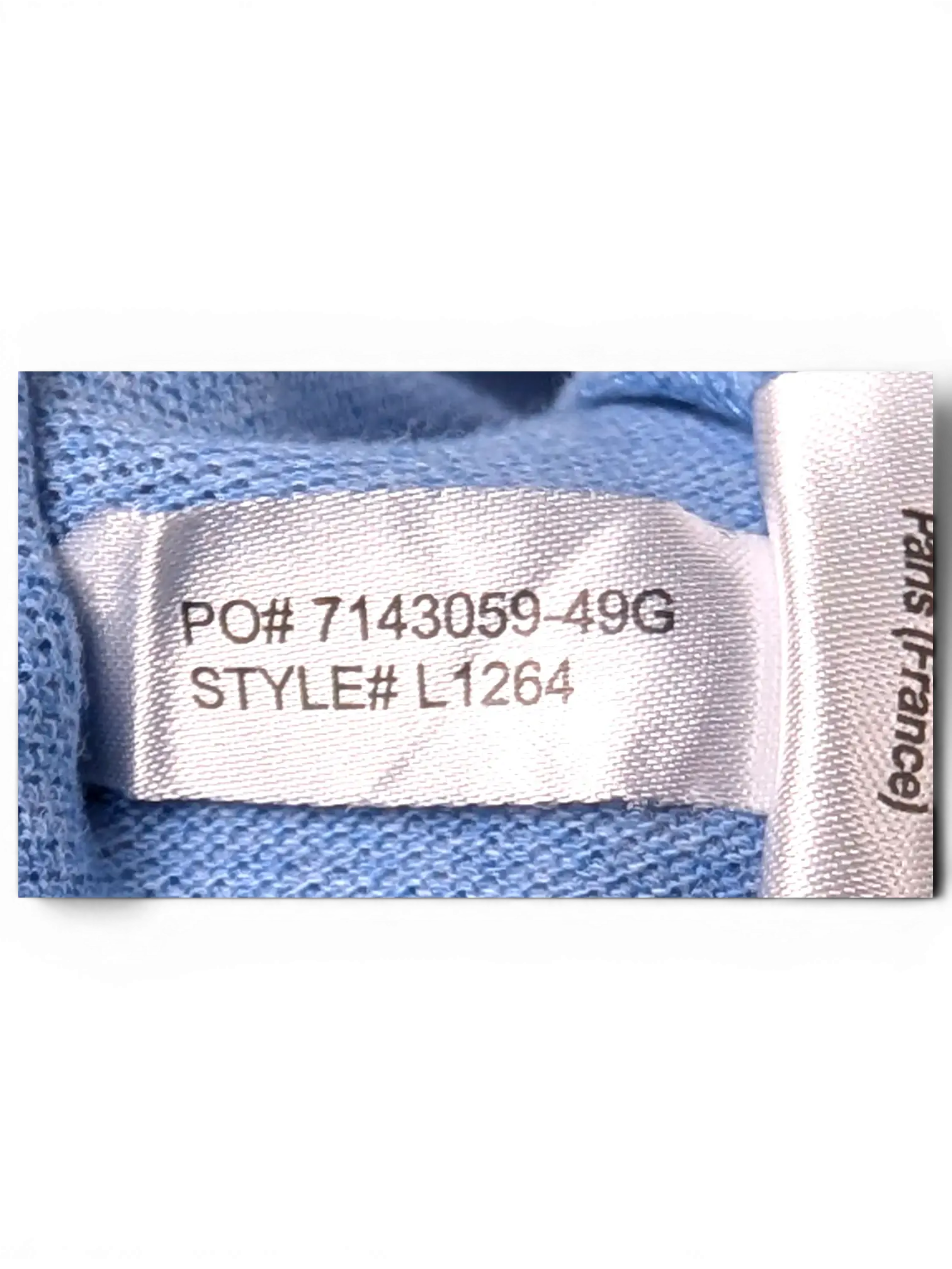 Interior care label and fabric detail of Lacoste Light Blue Polo Shirt