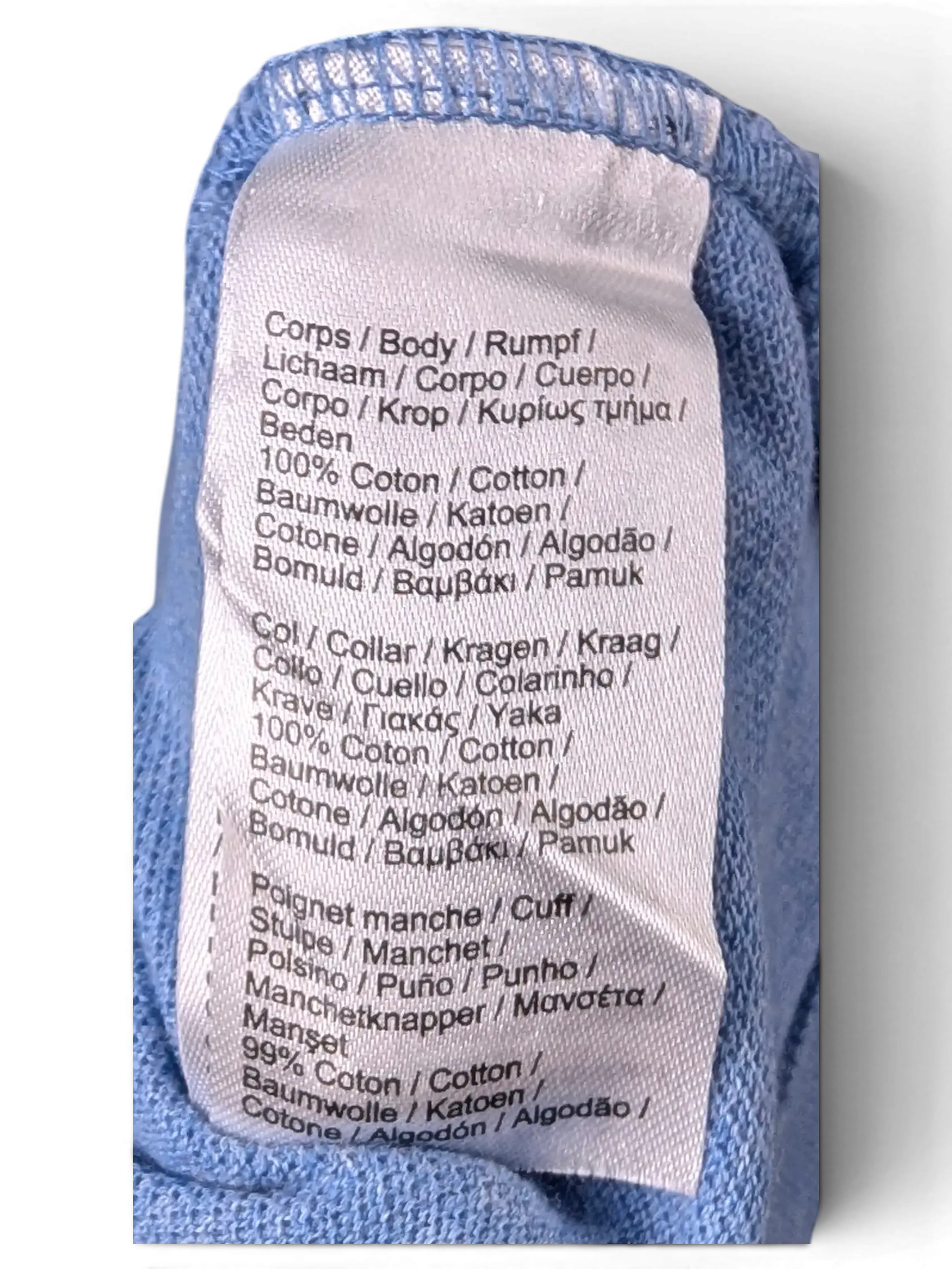 Fabric composition and care label detail of Lacoste Light Blue Polo Shirt
