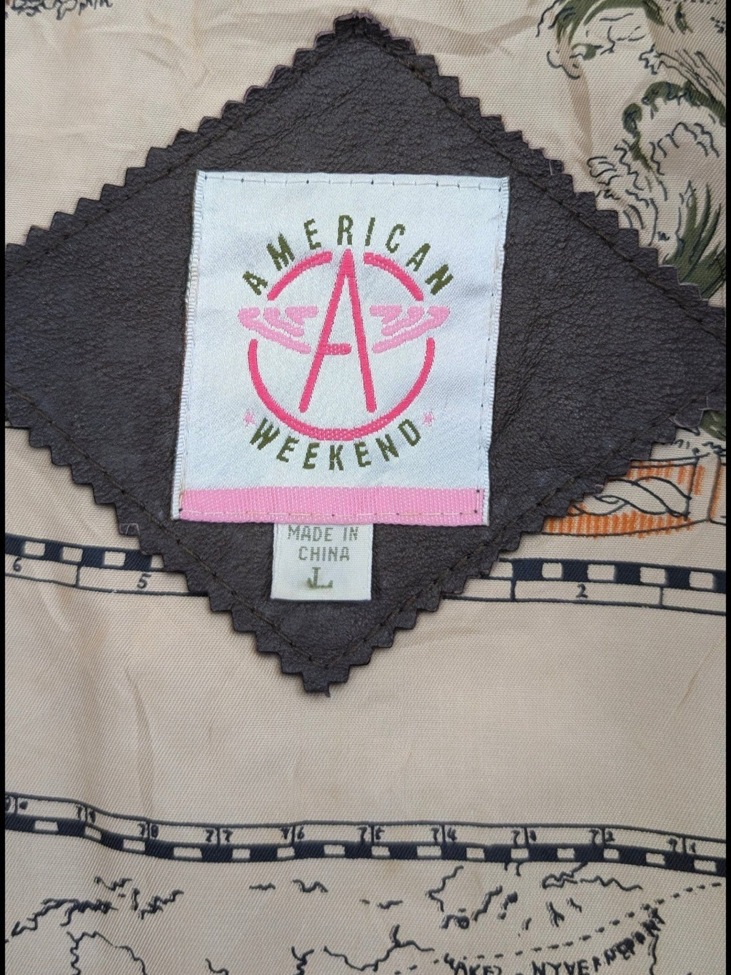 JAKE & IPI American Weekend leather jacket with a map print lining. Features a dark brown diamond-shaped panel.