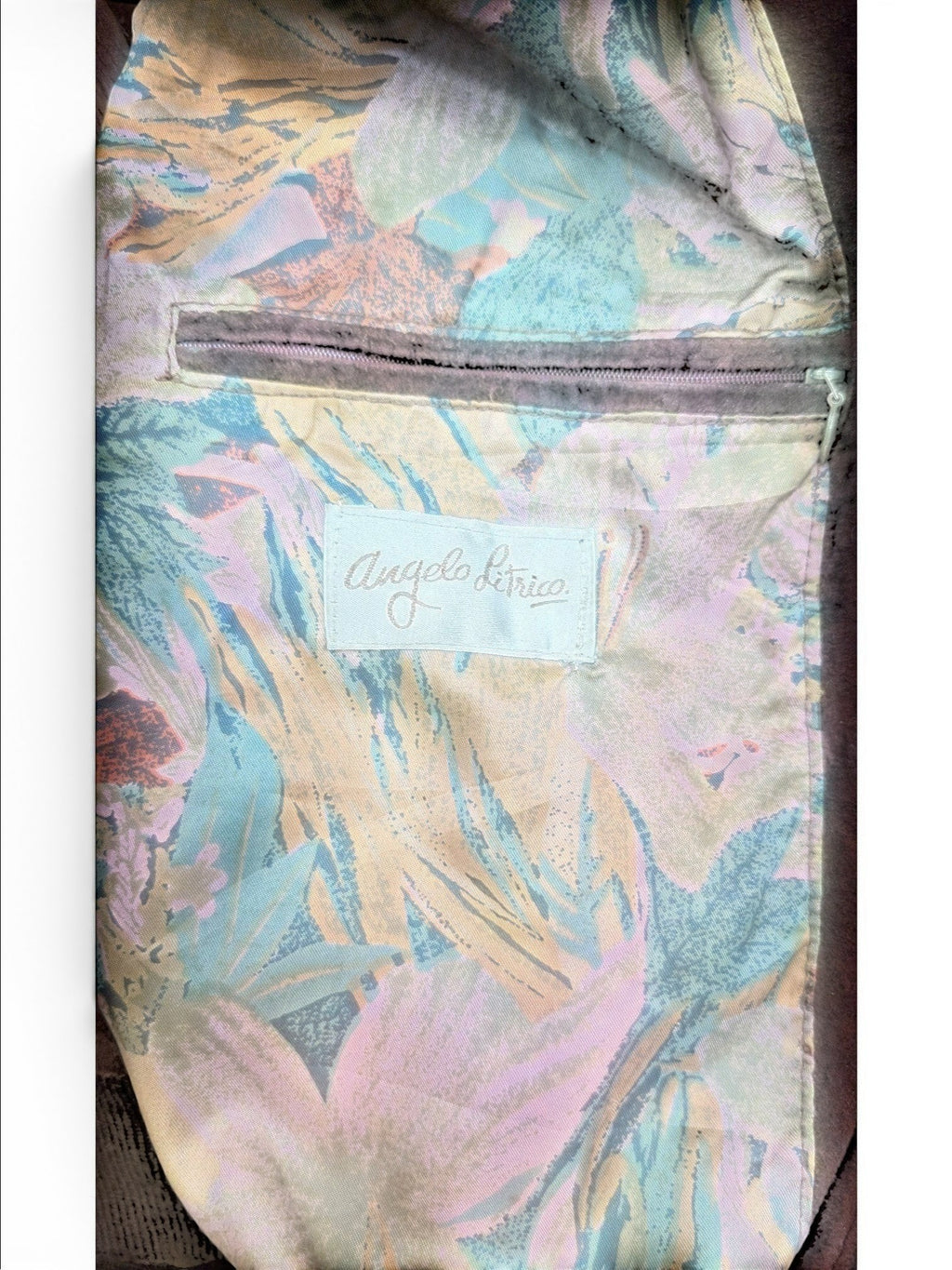 Angelo Litrico brown leather jacket lining with a floral print in green, orange, and pink. Features a zip pocket.