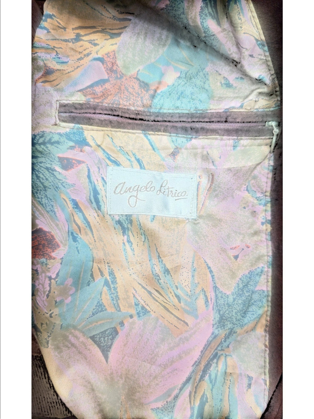 Angelo Litrico brown leather jacket lining with a floral print in green, orange, and pink. Features a zip pocket.