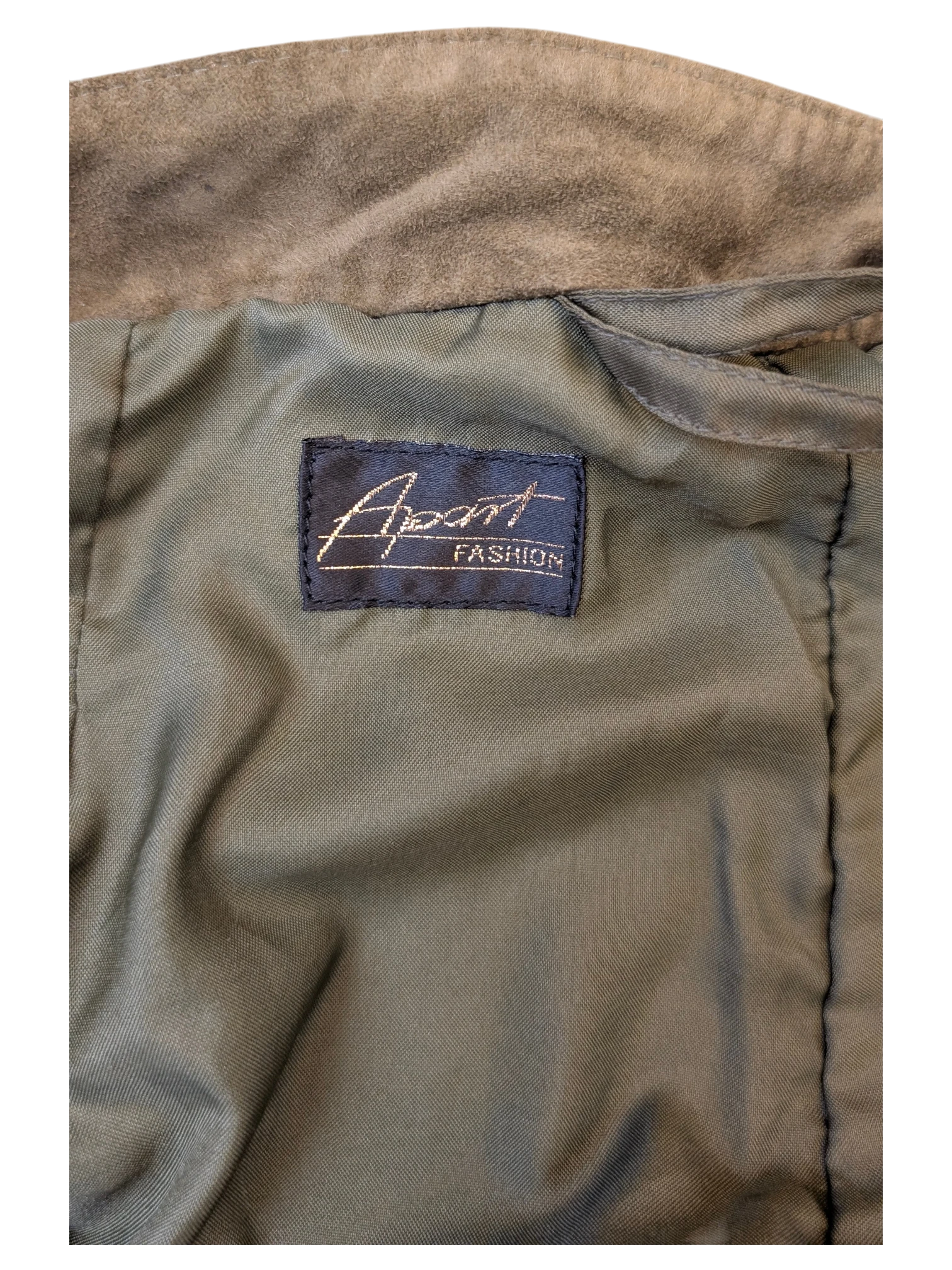 Interior label of a JAKE & IPI Apart Fashion suede skirt featuring olive green lining and soft brown suede fabric.