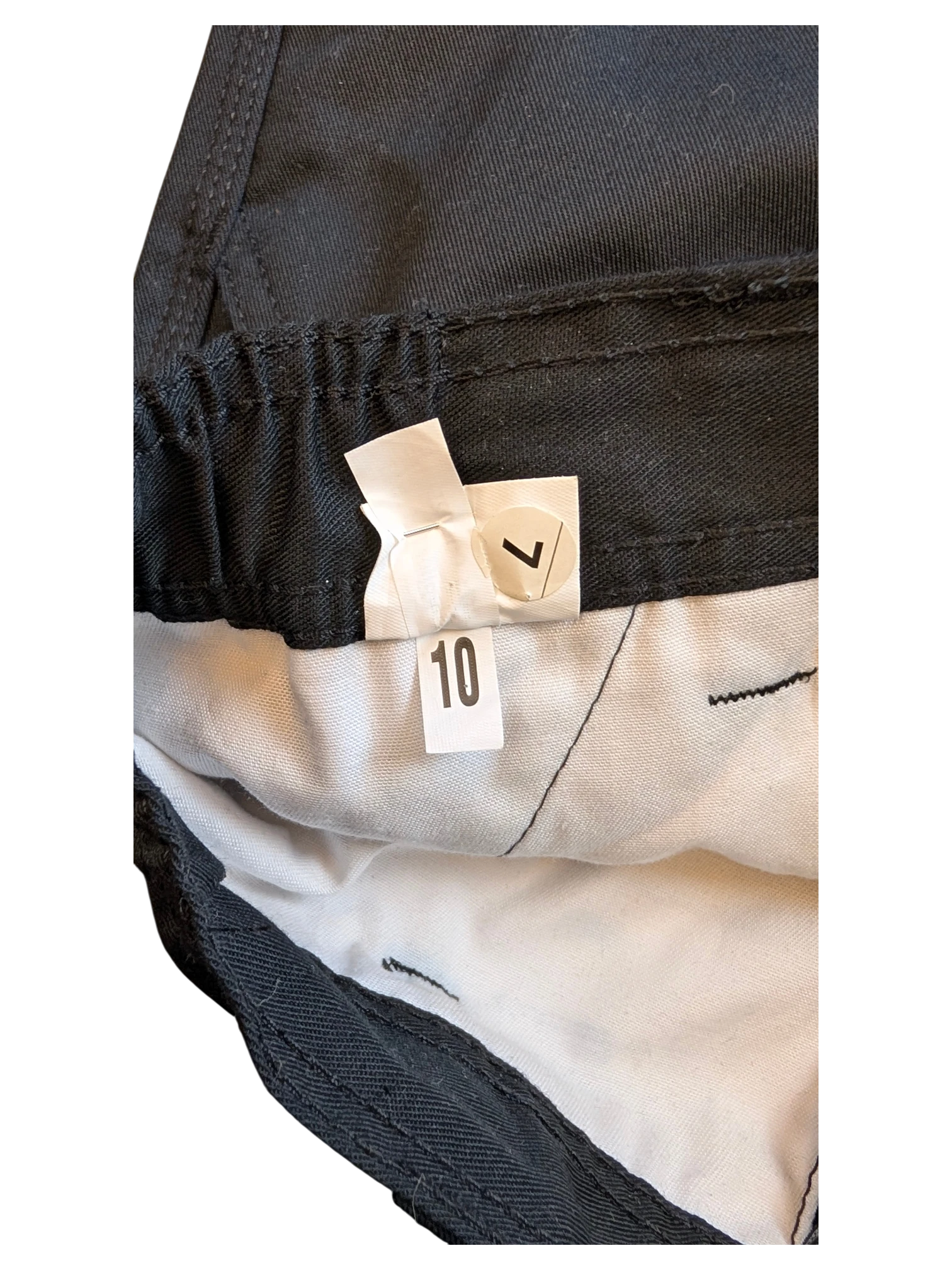 JAKE & IPI black cargo pants with size 10 tag and a size 7 tag.