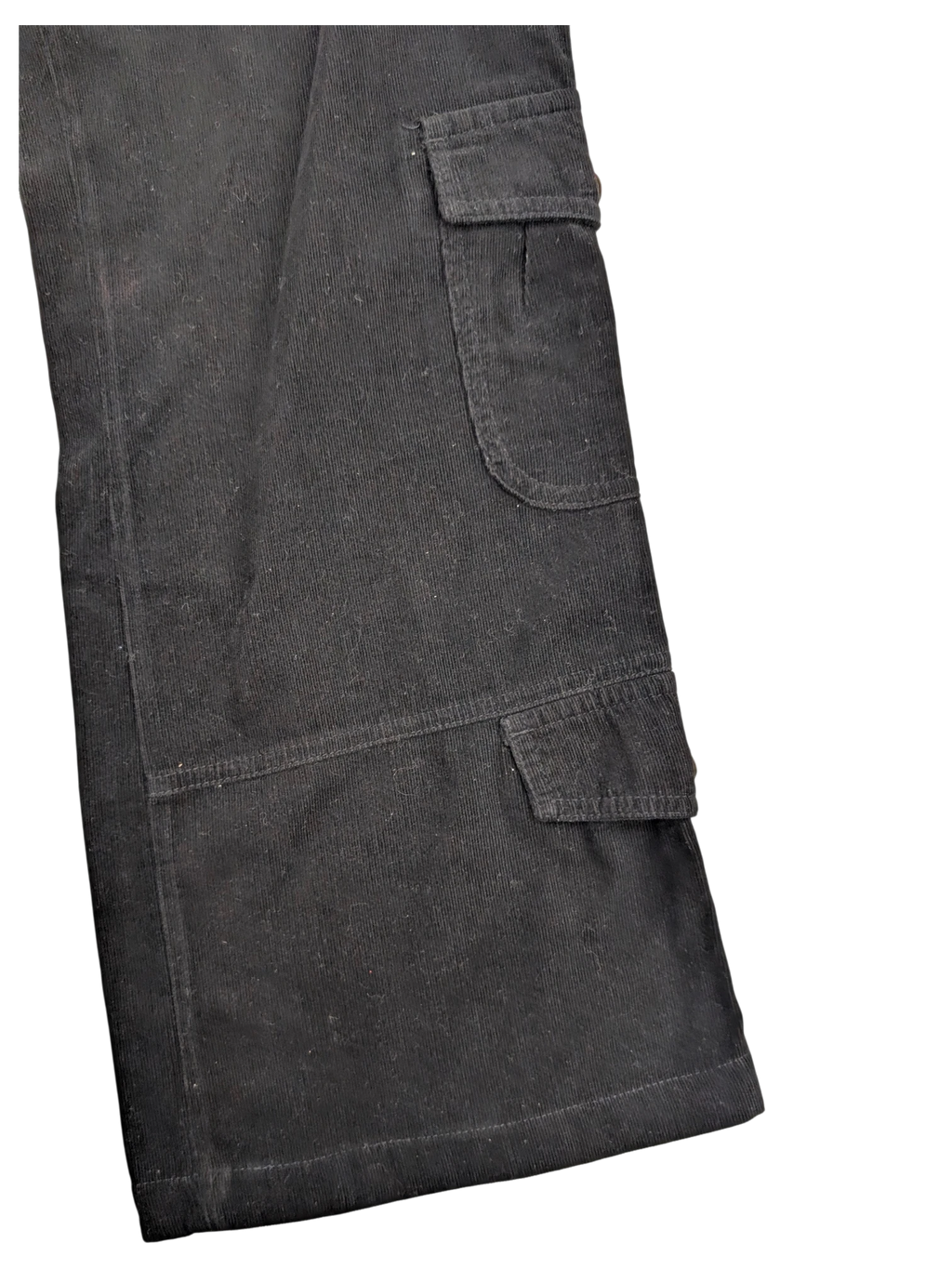 JAKE & IPI black corduroy cargo pants with button flap pockets and visible stitching detail.