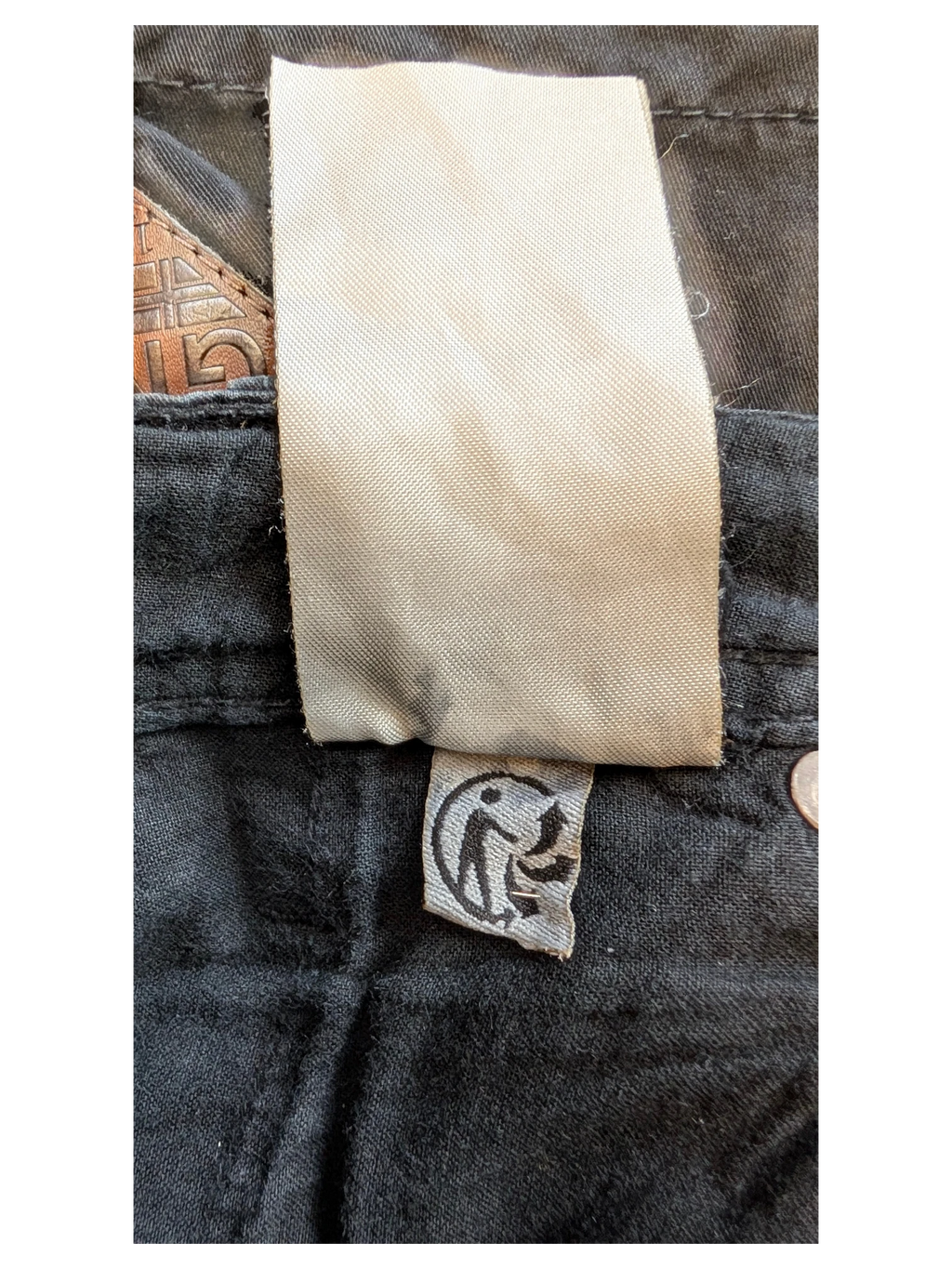 JAKE & IPI black cotton blend trousers with a woven label and a small tag featuring a circular logo.