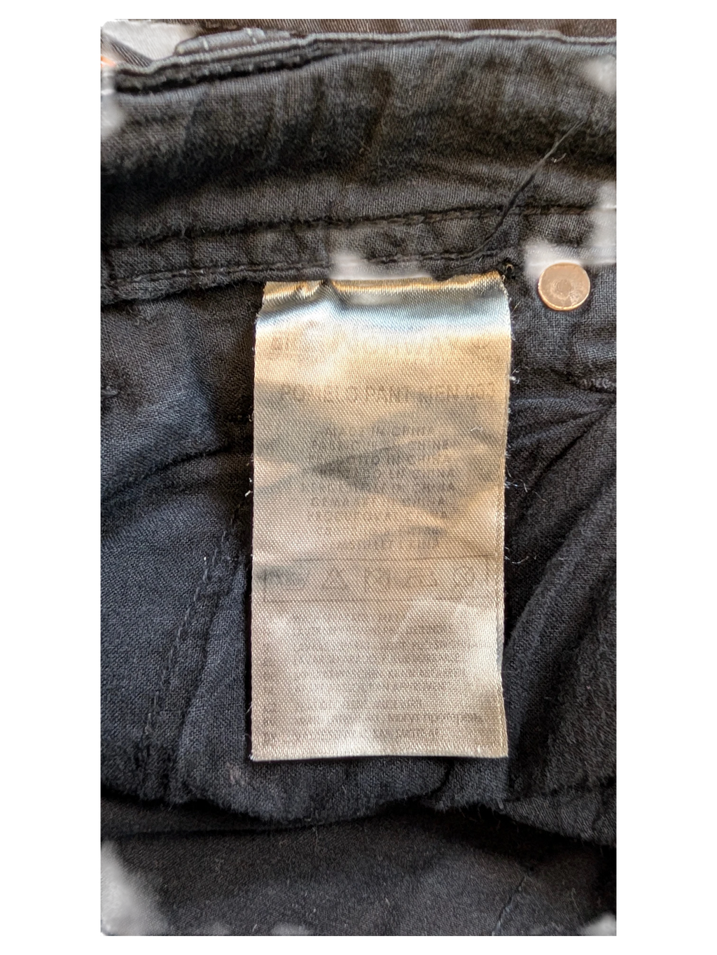 JAKE & IPI black denim jeans with care label detail.