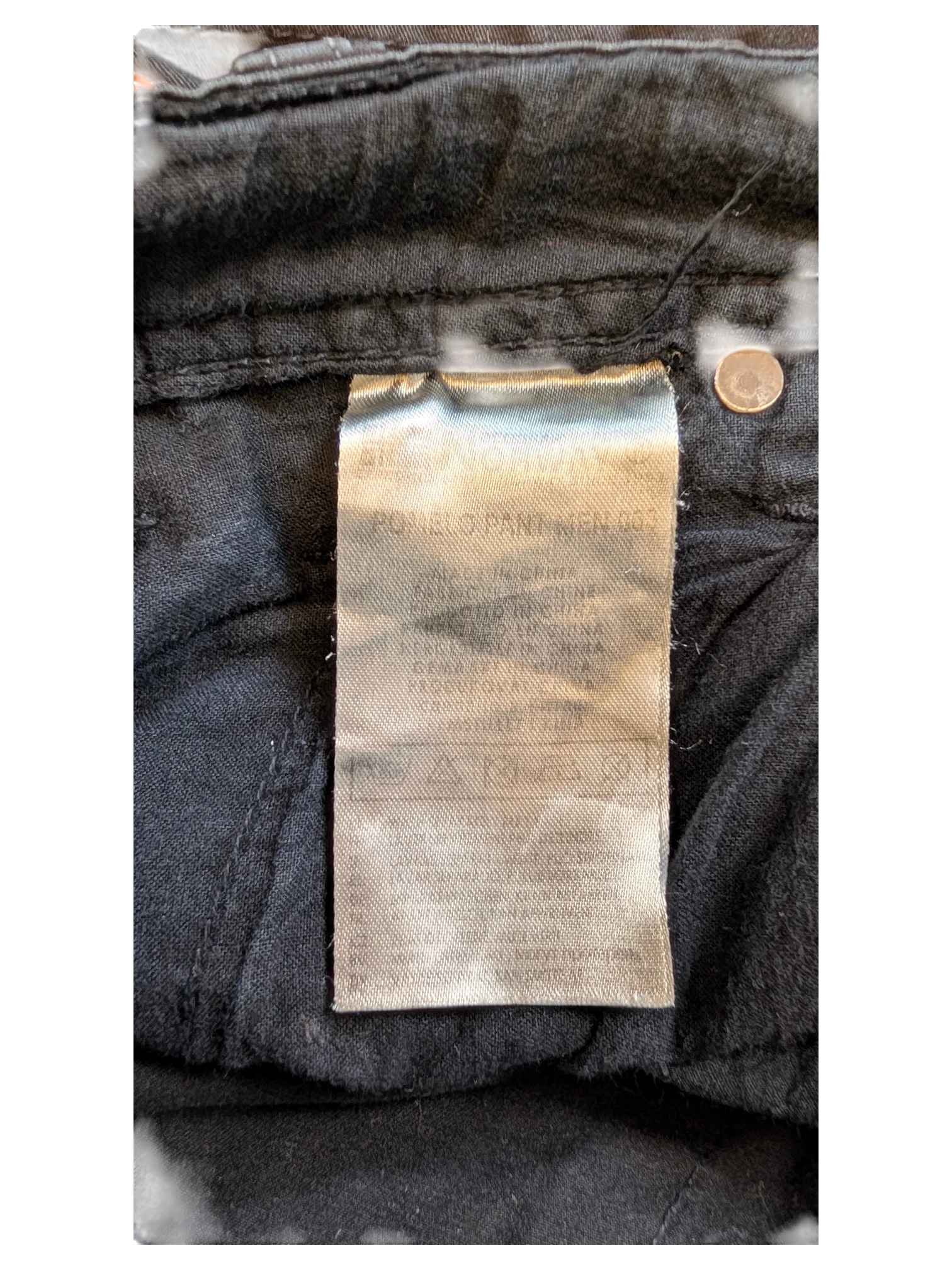 JAKE & IPI black denim jeans with care label detail.