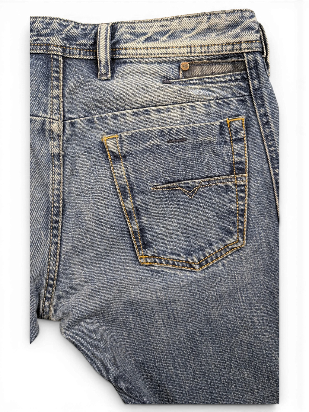 JAKE & IPI blue denim jeans with a distressed wash, featuring a V-stitch detail on the back pocket and a button closure.