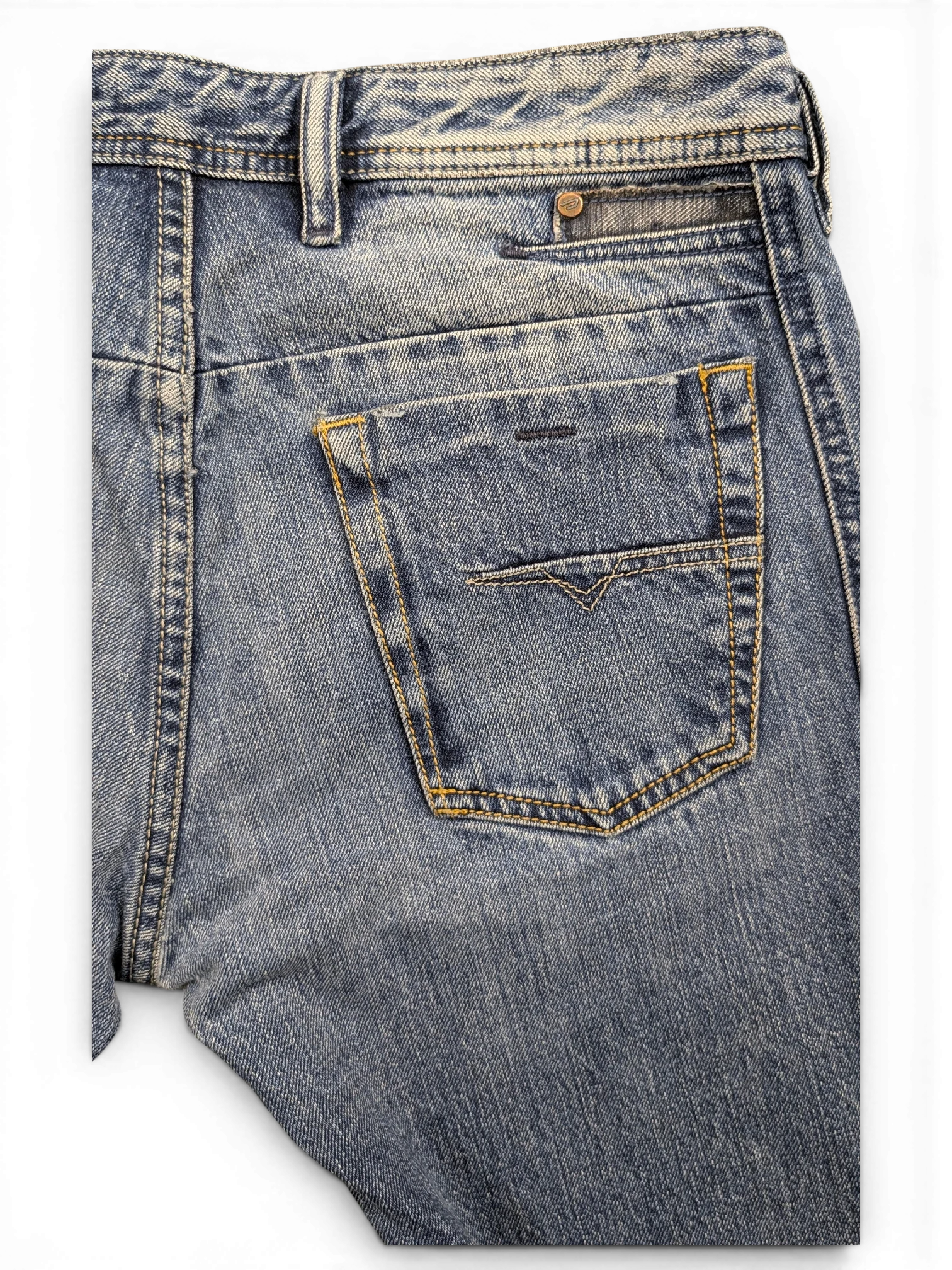 JAKE & IPI blue denim jeans with a distressed wash, featuring a V-stitch detail on the back pocket and a button closure.