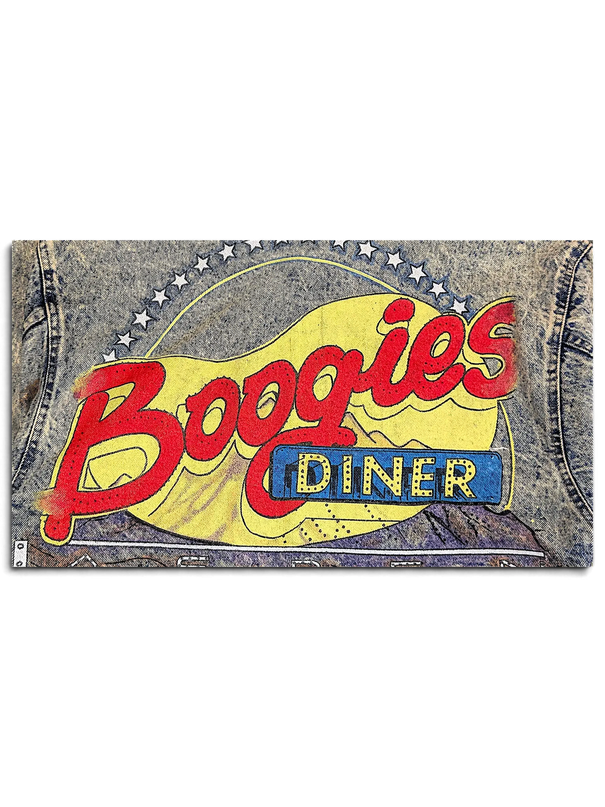 Close-up of the JAKE & IPI Alamo Boogies Diner denim jacket featuring a vintage-style graphic print on acid wash denim