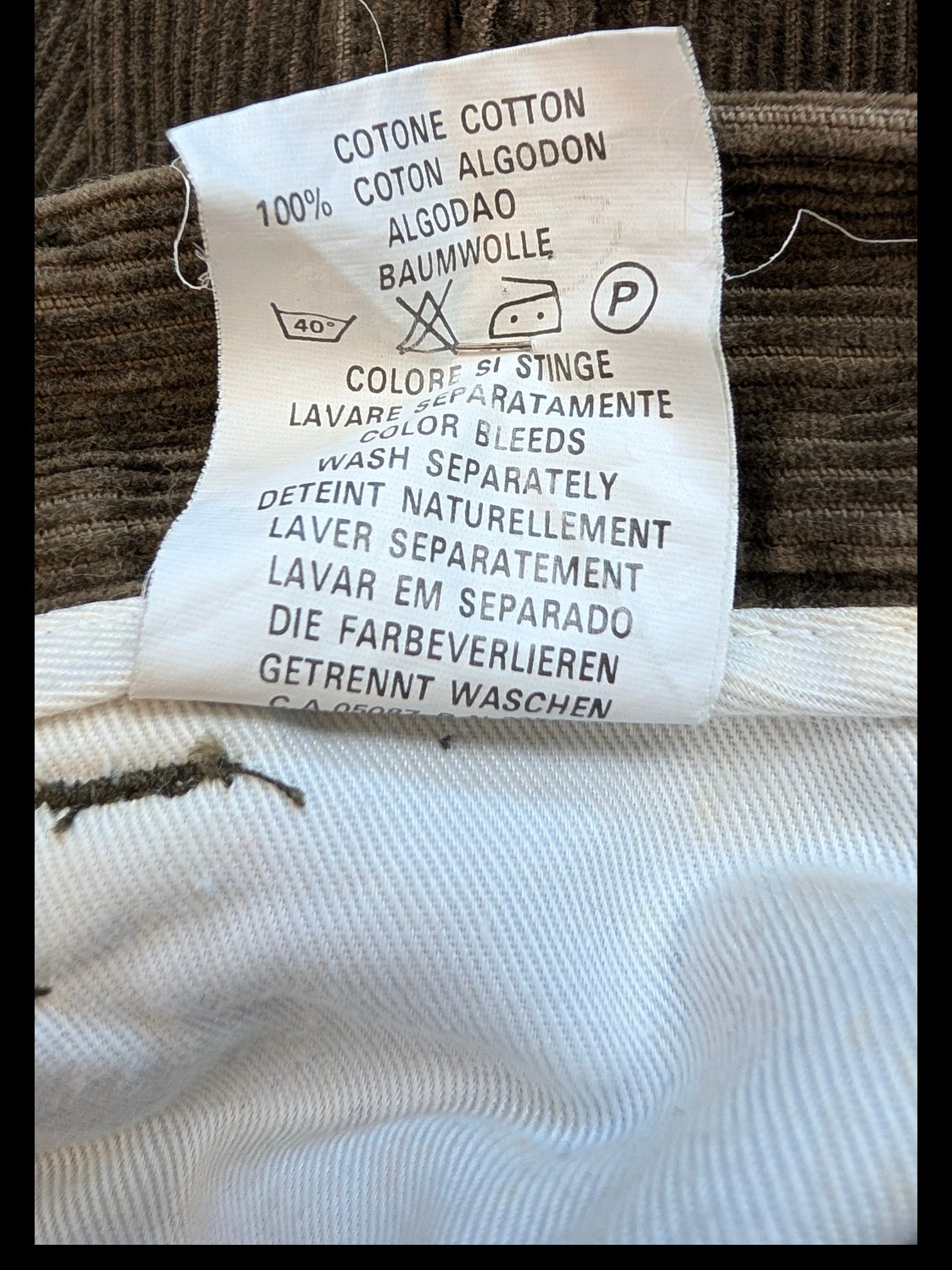 JAKE & IPI brown 100% cotton corduroy cargo pants with care label details.