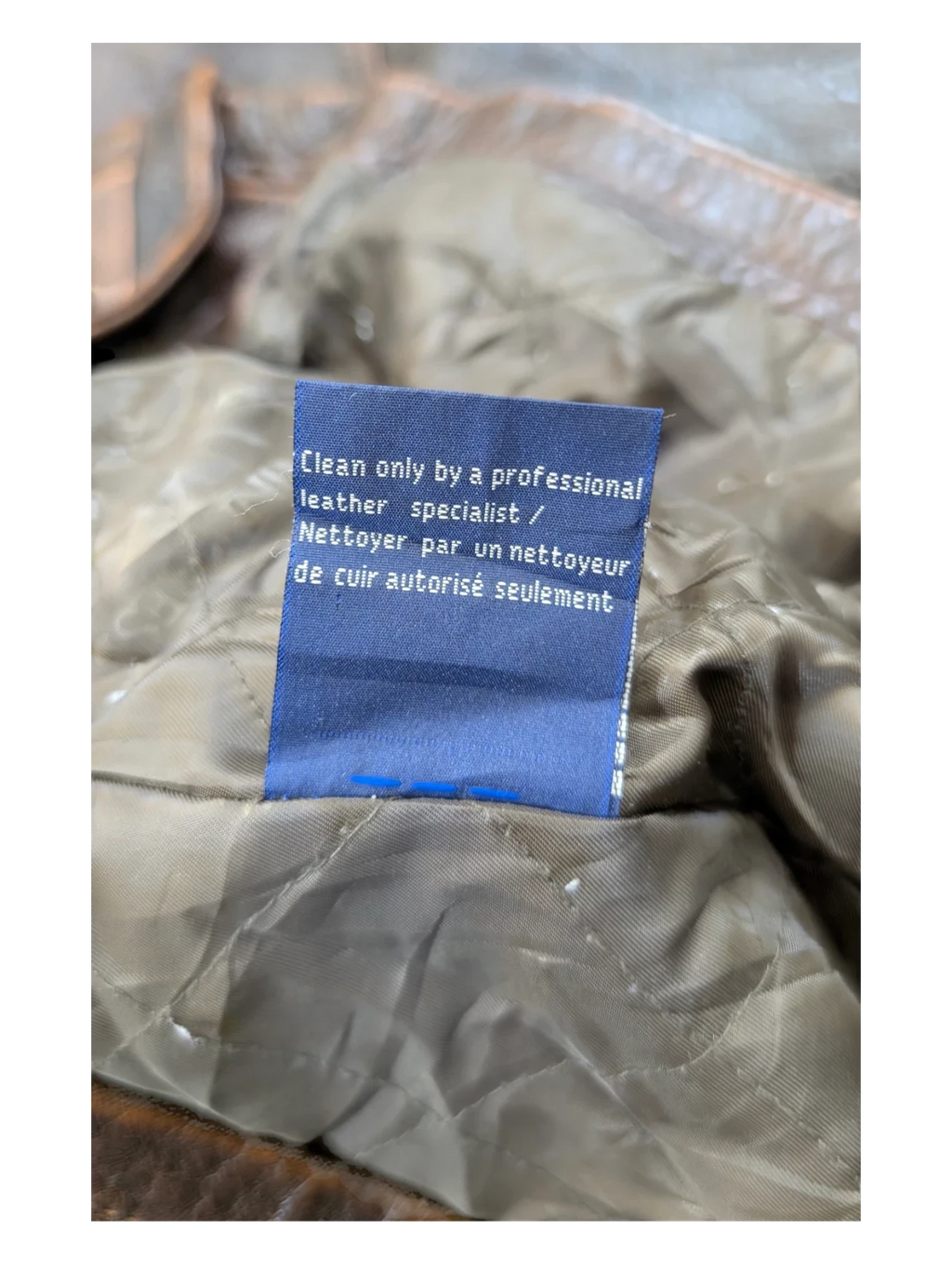 JAKE & IPI brown leather jacket with quilted lining and care tag.