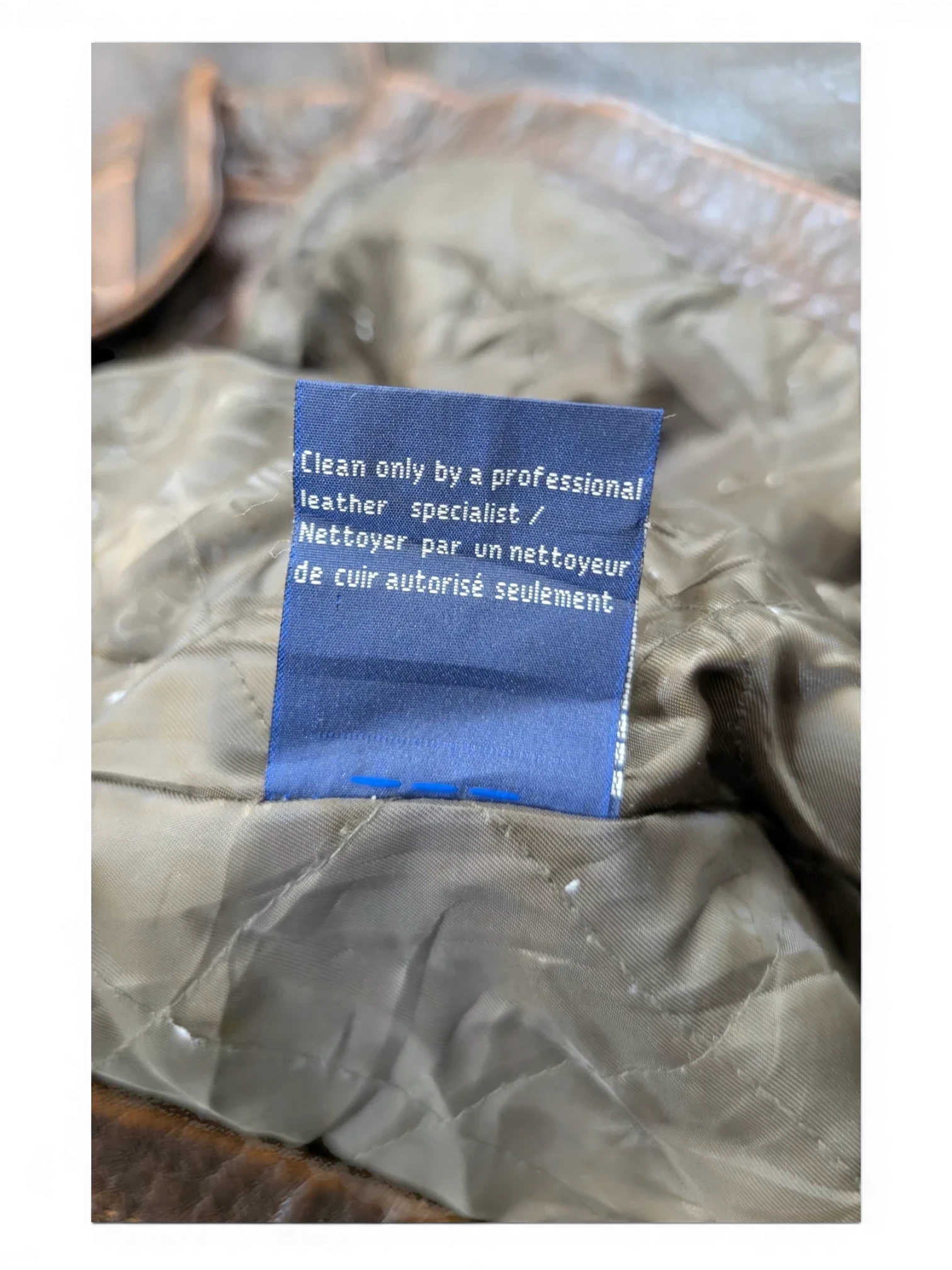 JAKE & IPI brown leather jacket with quilted lining and care tag.