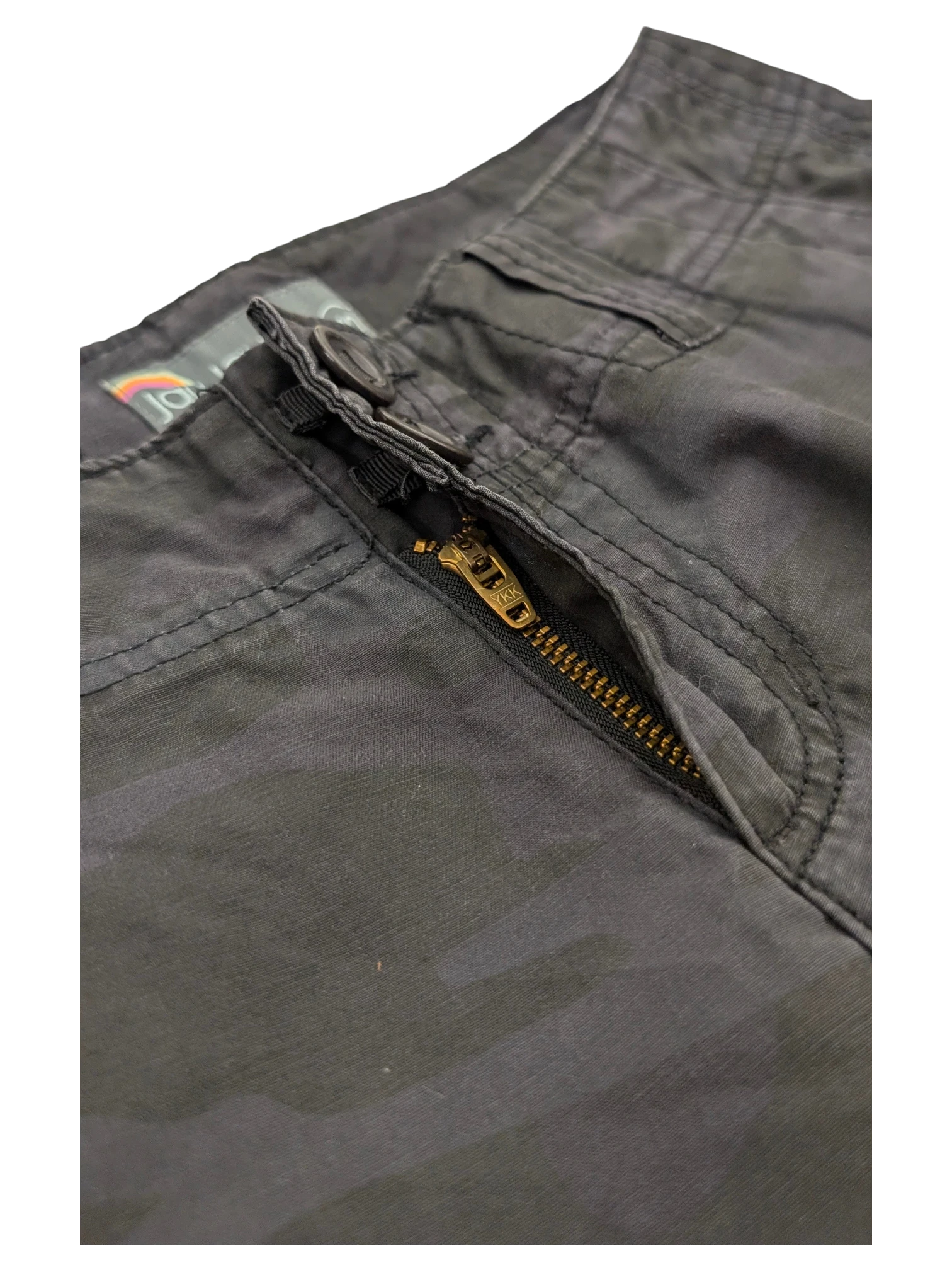 JAKE & IPI dark grey camo cargo pants with a brass zipper and button closure.