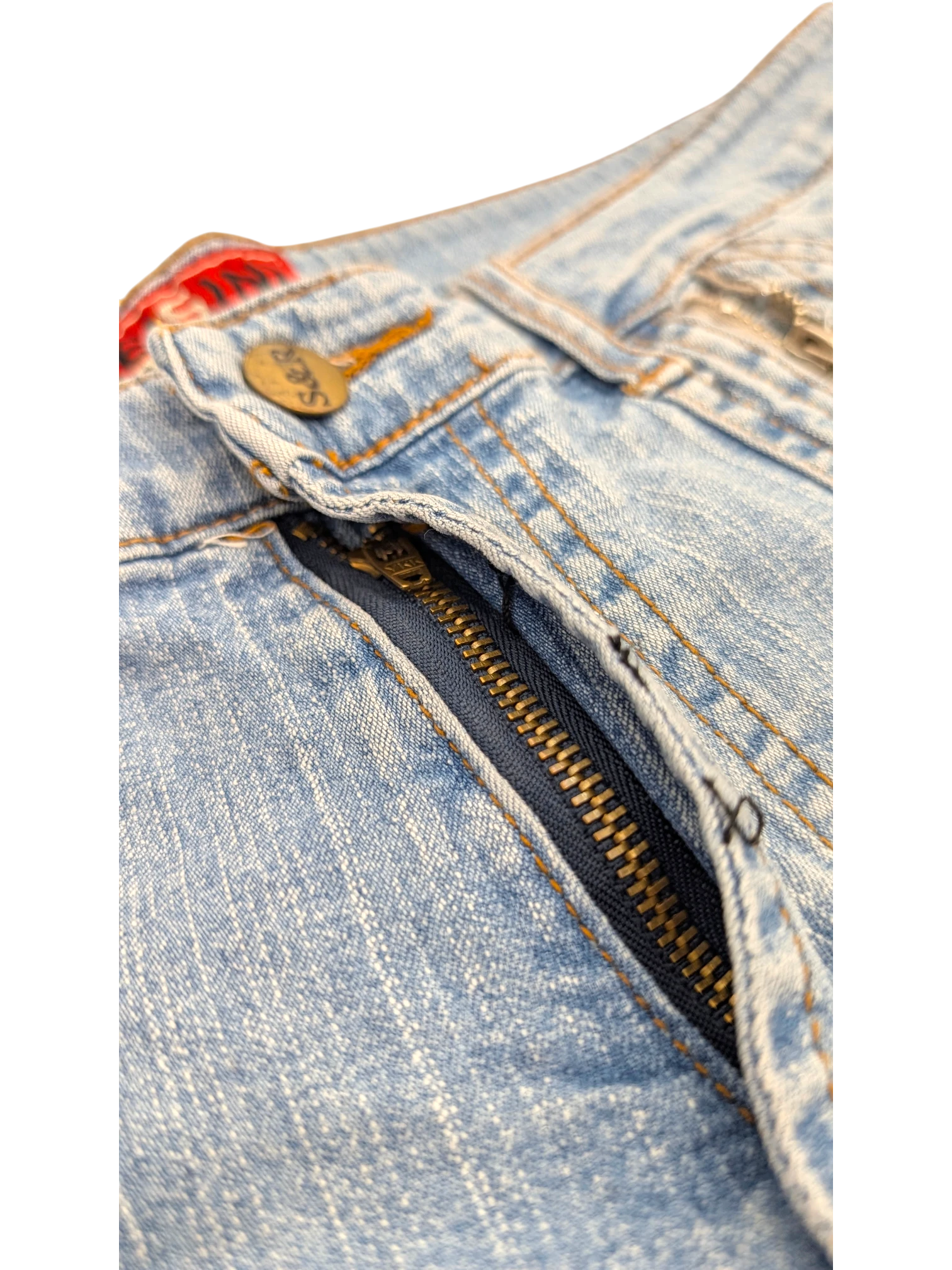 JAKE & IPI light wash denim cargo jeans with brass button and zipper detail.