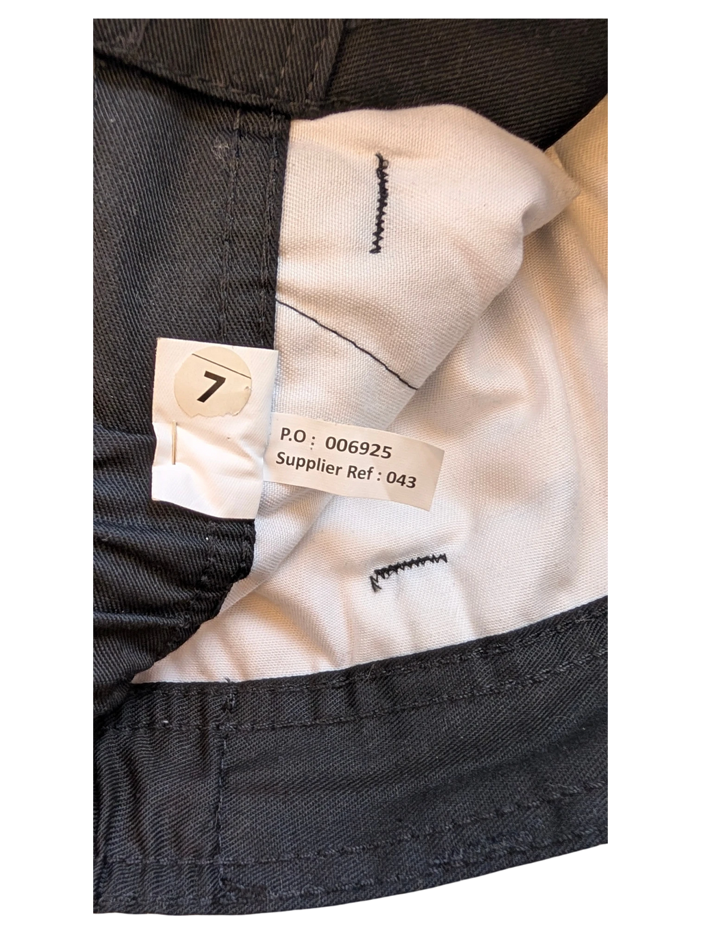 JAKE & IPI dark grey cargo pants size 7 with internal tags showing P.O. and supplier reference.