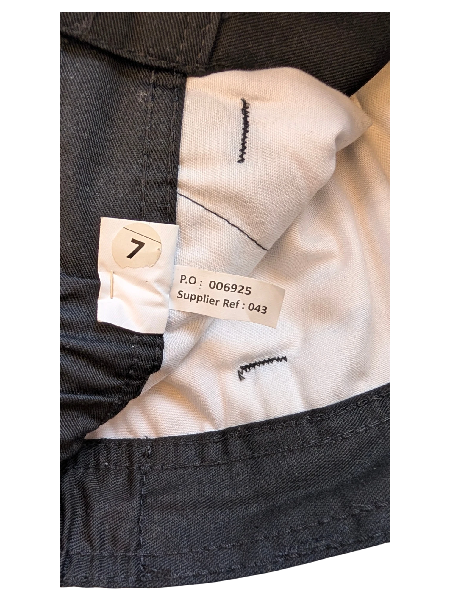 JAKE & IPI dark grey cargo pants size 7 with internal tags showing P.O. and supplier reference.