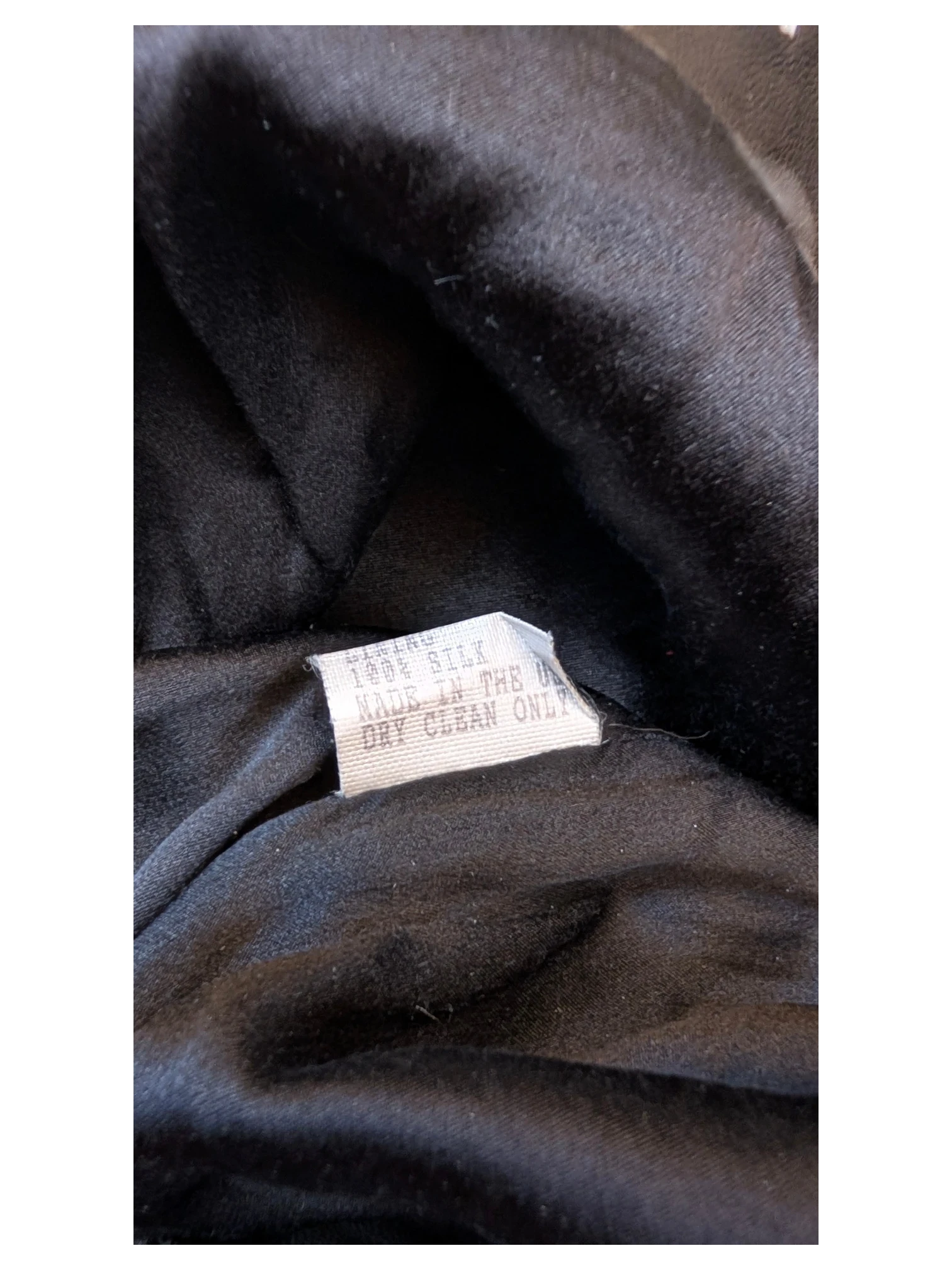 JAKE & IPI Carolina Herrera leather skirt interior showing 100% silk lining and care tag, made in the USA.