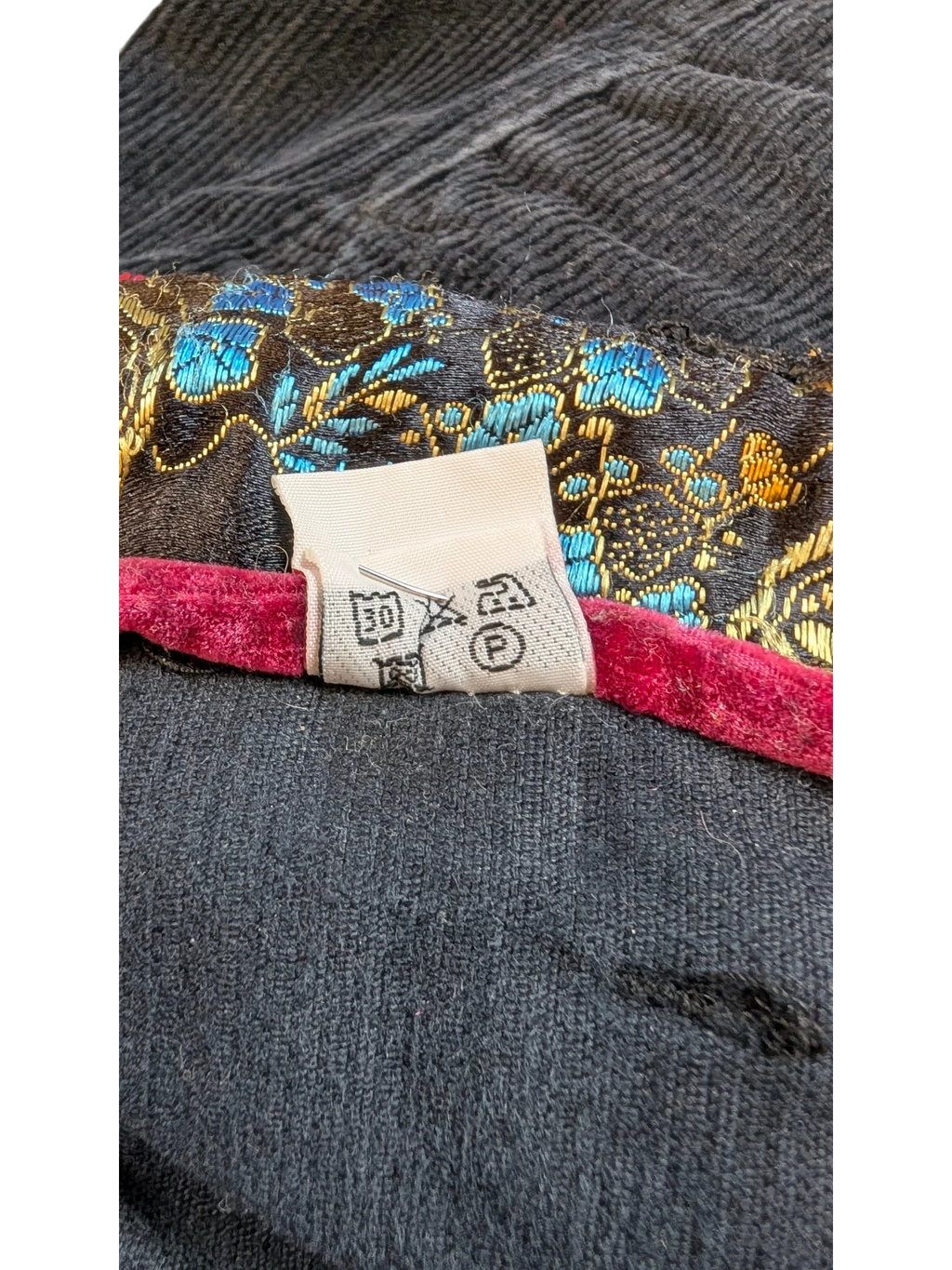 JAKE & IPI dark grey corduroy cargo pants with ornate floral lining and care tag.
