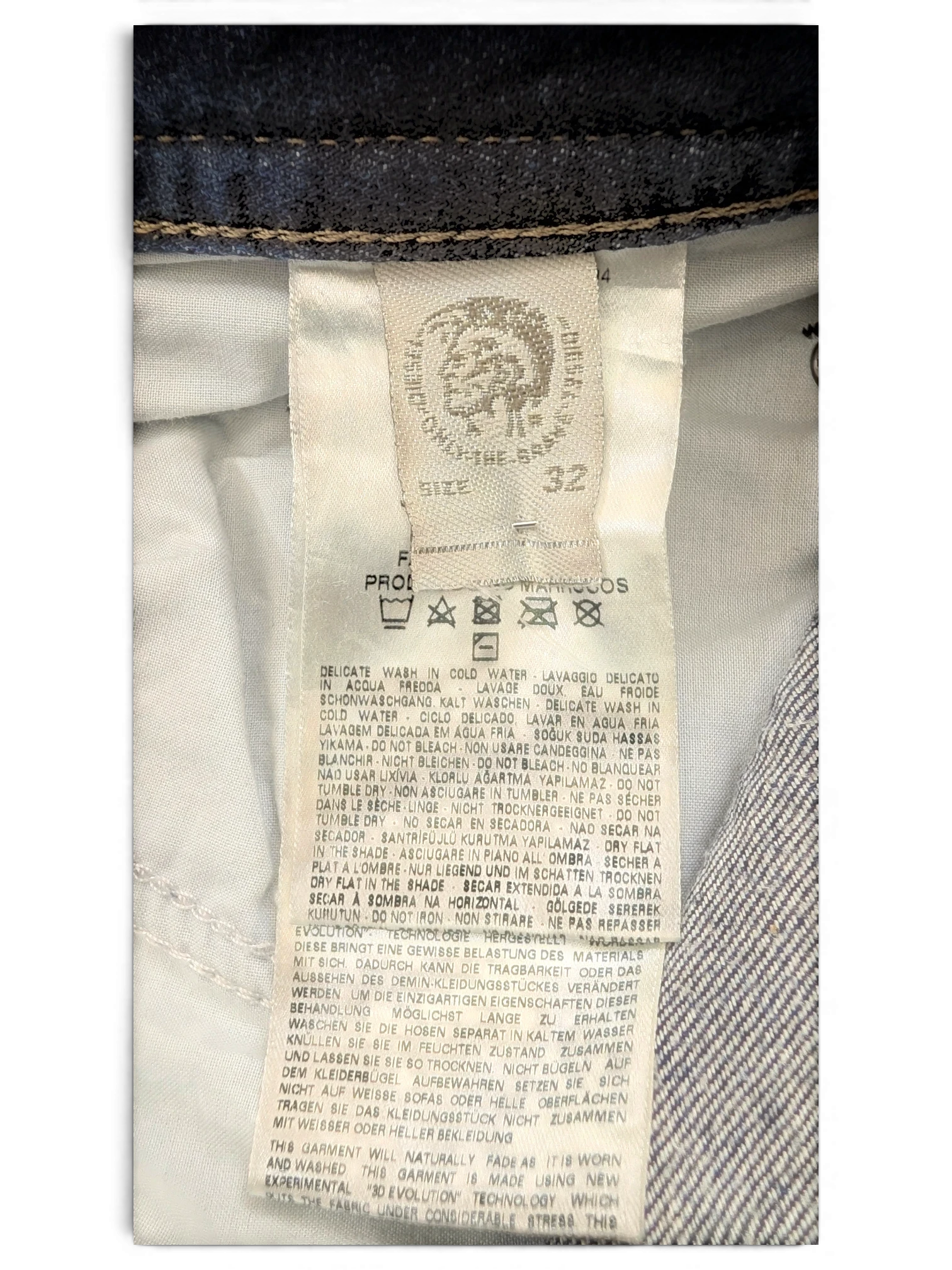 JAKE & IPI Diesel Buster jeans size 32, dark wash denim with care instructions and brand logo.