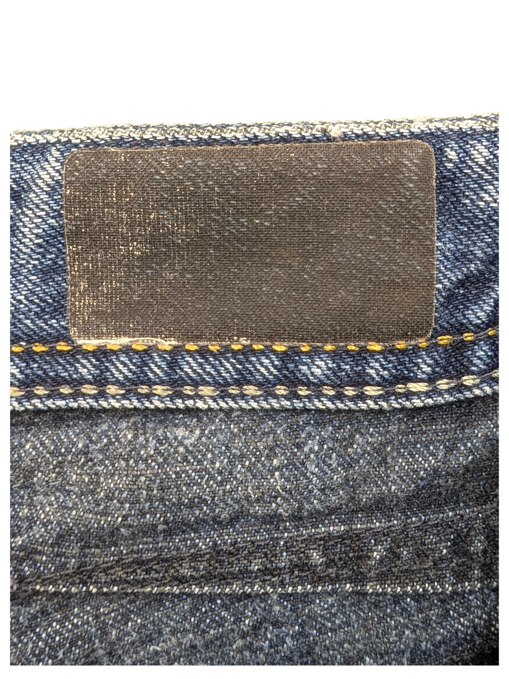 JAKE & IPI dark wash denim jeans with a black leather patch and yellow stitching detail.