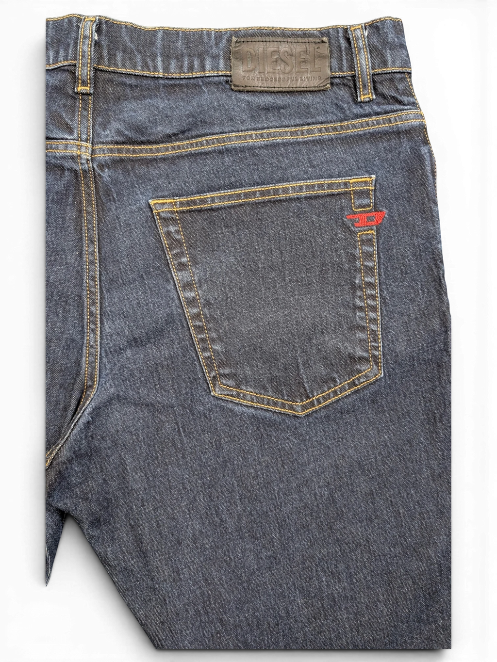 JAKE & IPI dark wash denim jeans with red Diesel logo detail on back pocket and leather brand patch.