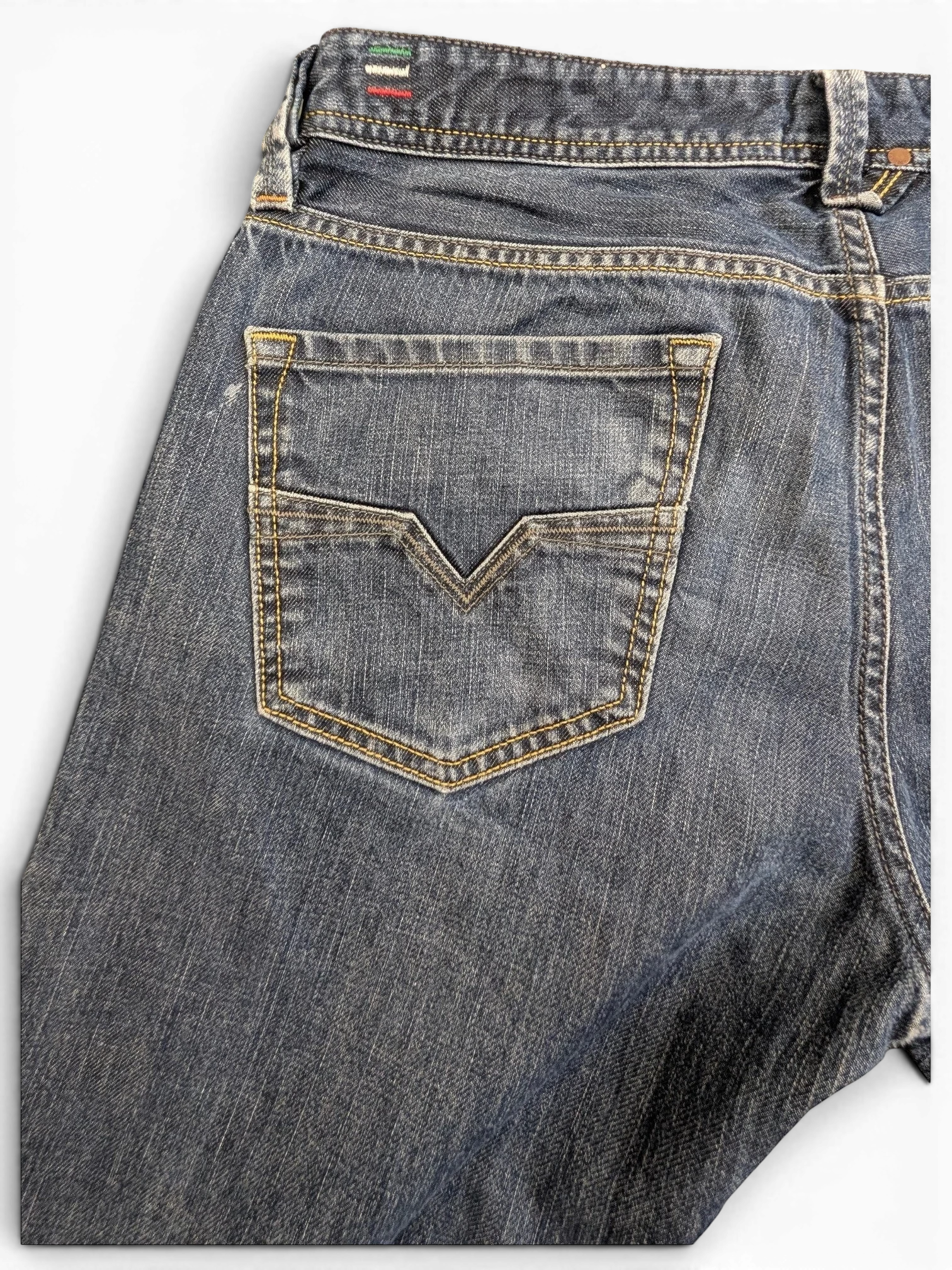 JAKE & IPI Diesel Larkee jeans in dark wash denim with V-stitch back pocket detail and contrast stitching.
