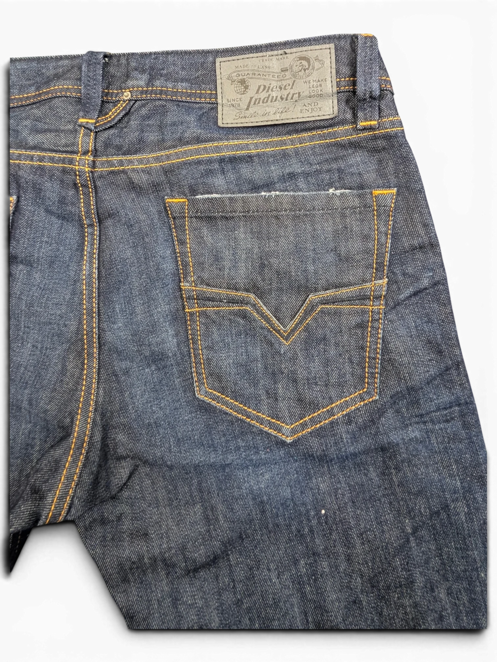 JAKE & IPI Diesel Larkee dark wash denim jeans with orange stitching and V-shaped back pocket detail.