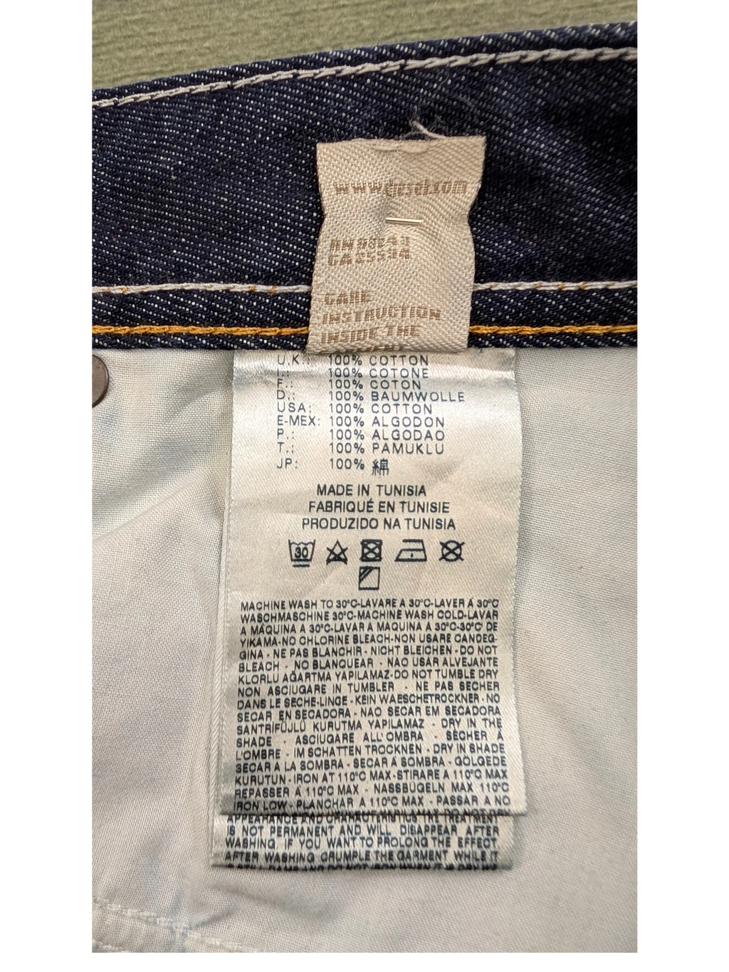 JAKE & IPI Diesel Larkee jeans care label with 100% cotton material and made in Tunisia details.