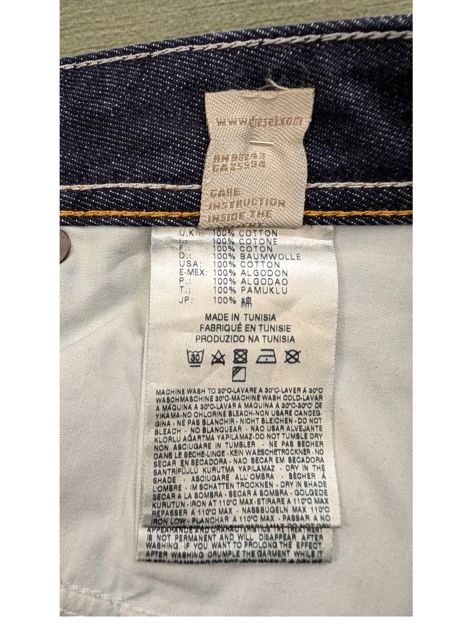 JAKE & IPI Diesel Larkee jeans care label with 100% cotton material and made in Tunisia details.