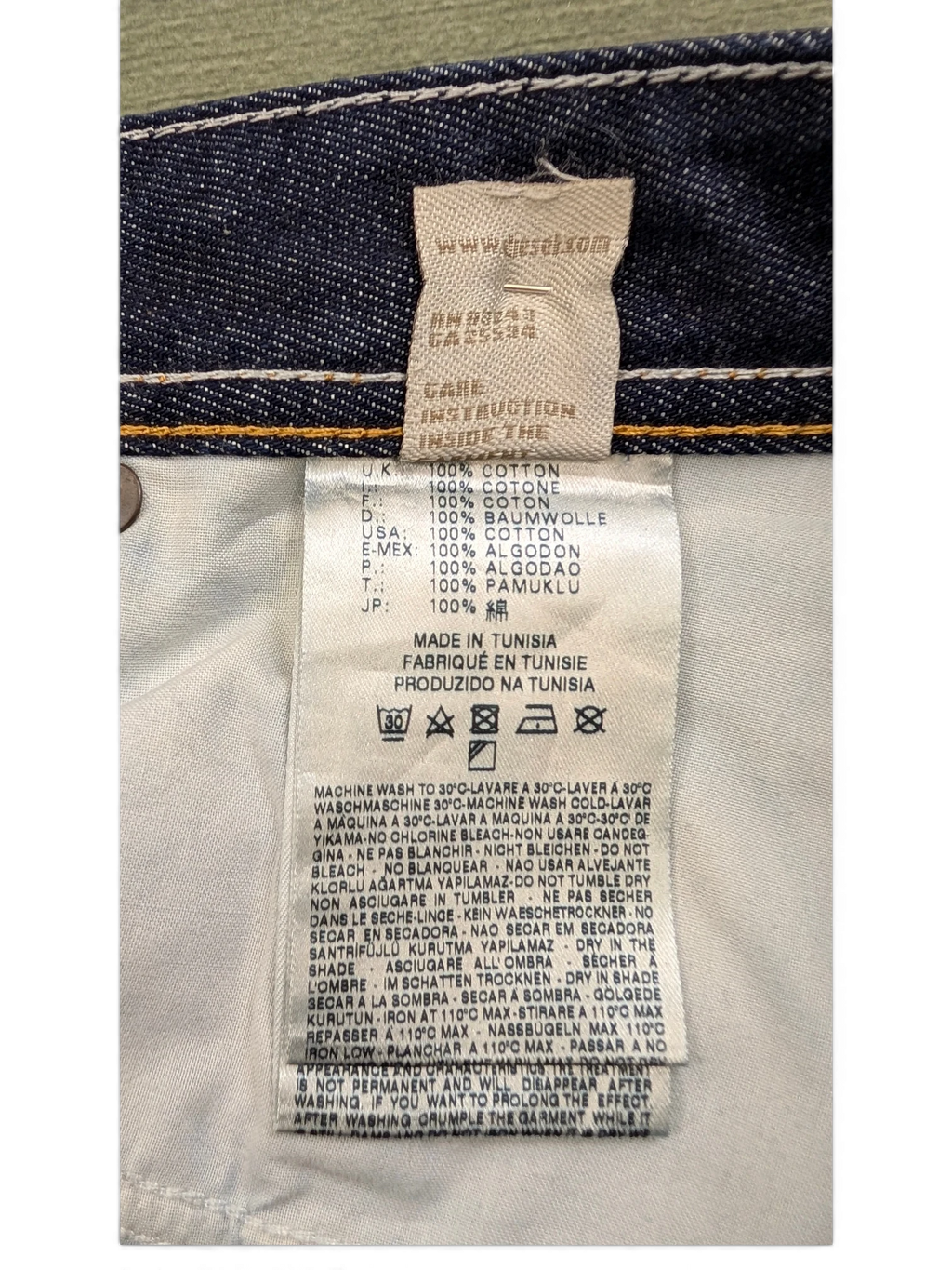JAKE & IPI Diesel Larkee jeans care label with 100% cotton material and made in Tunisia details.