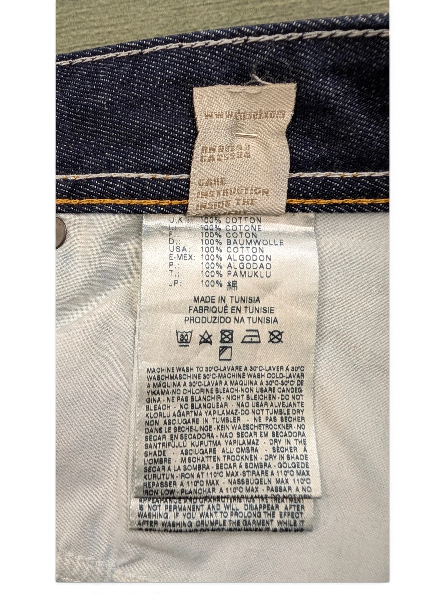 JAKE & IPI Diesel Larkee jeans care label with 100% cotton material and made in Tunisia details.