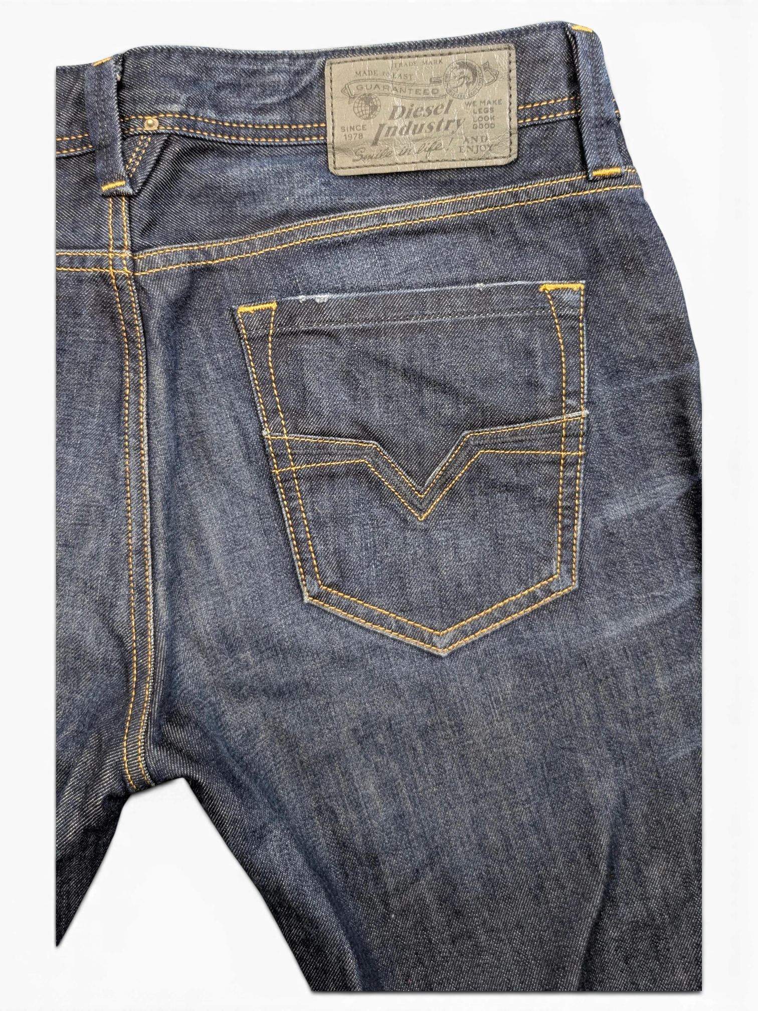 JAKE & IPI Diesel Larkee dark wash denim jeans with yellow stitching and V-shaped back pocket detail.