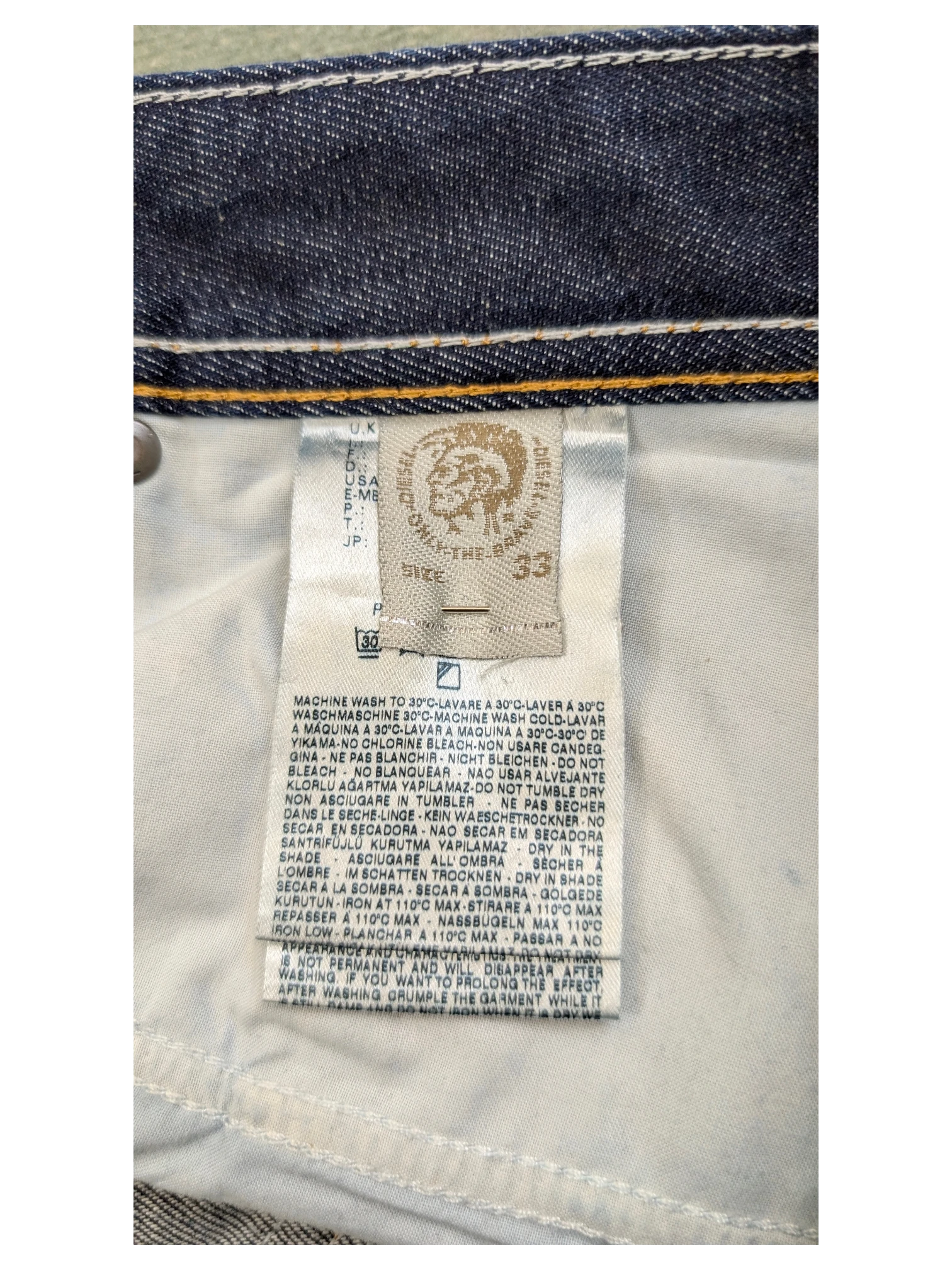 JAKE & IPI Diesel Larkee jeans size 33, dark wash denim with white stitching detail.