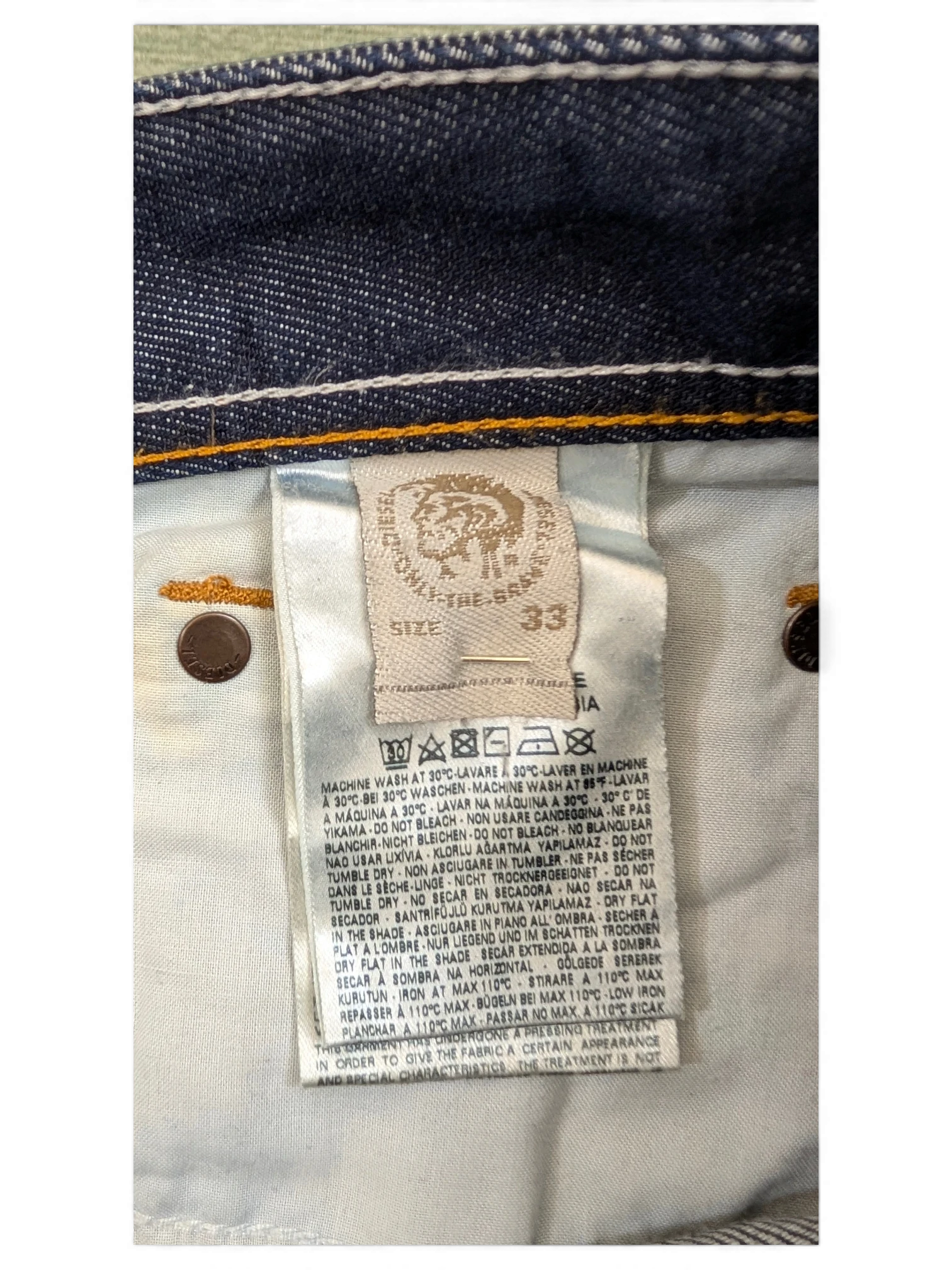 JAKE & IPI Diesel Larkee jeans size 33, dark wash denim with white stitching and branded button.
