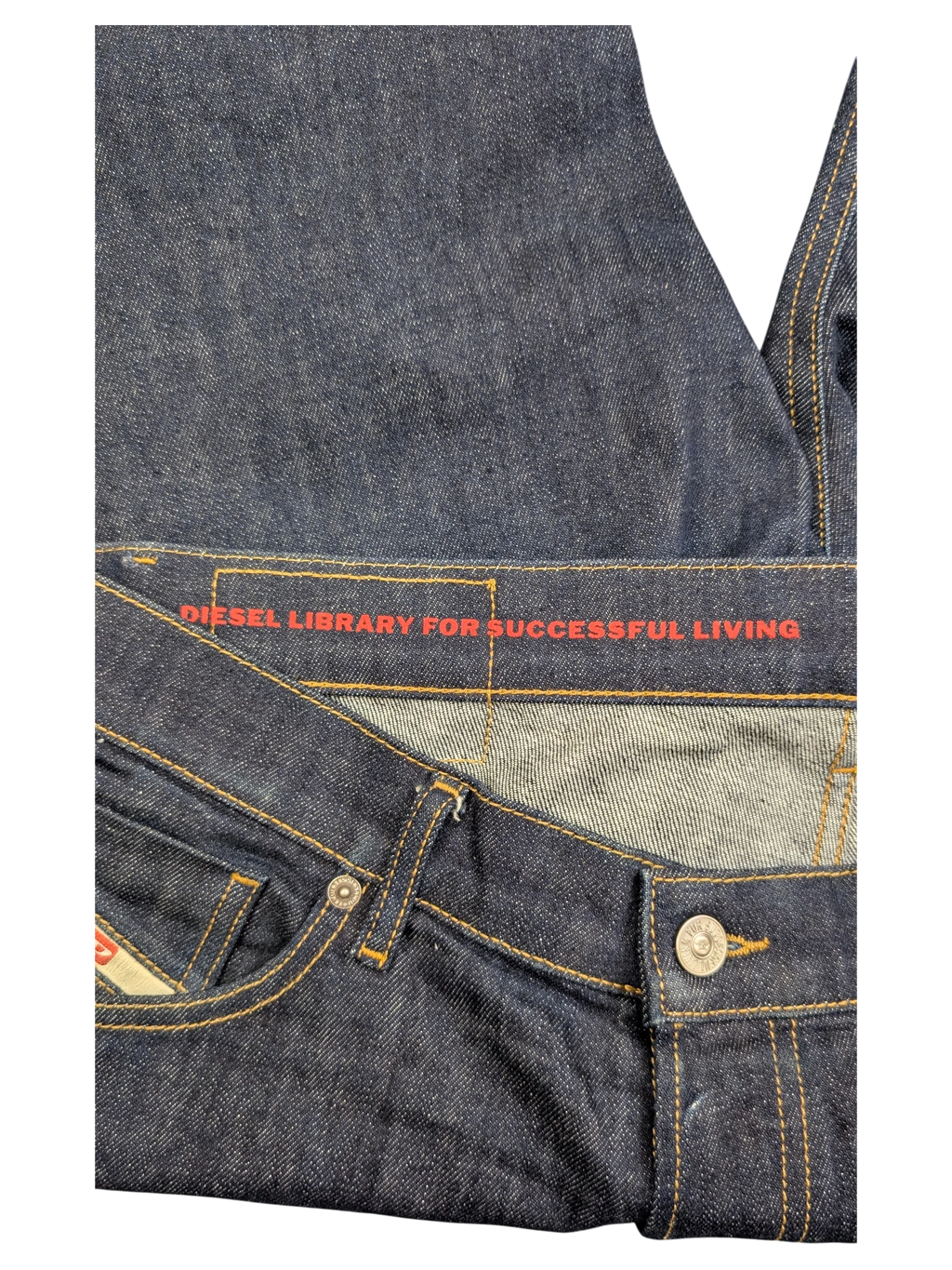JAKE & IPI dark wash denim jeans with red "DIESEL LIBRARY FOR SUCCESSFUL LIVING" waistband detail. W34 L32.