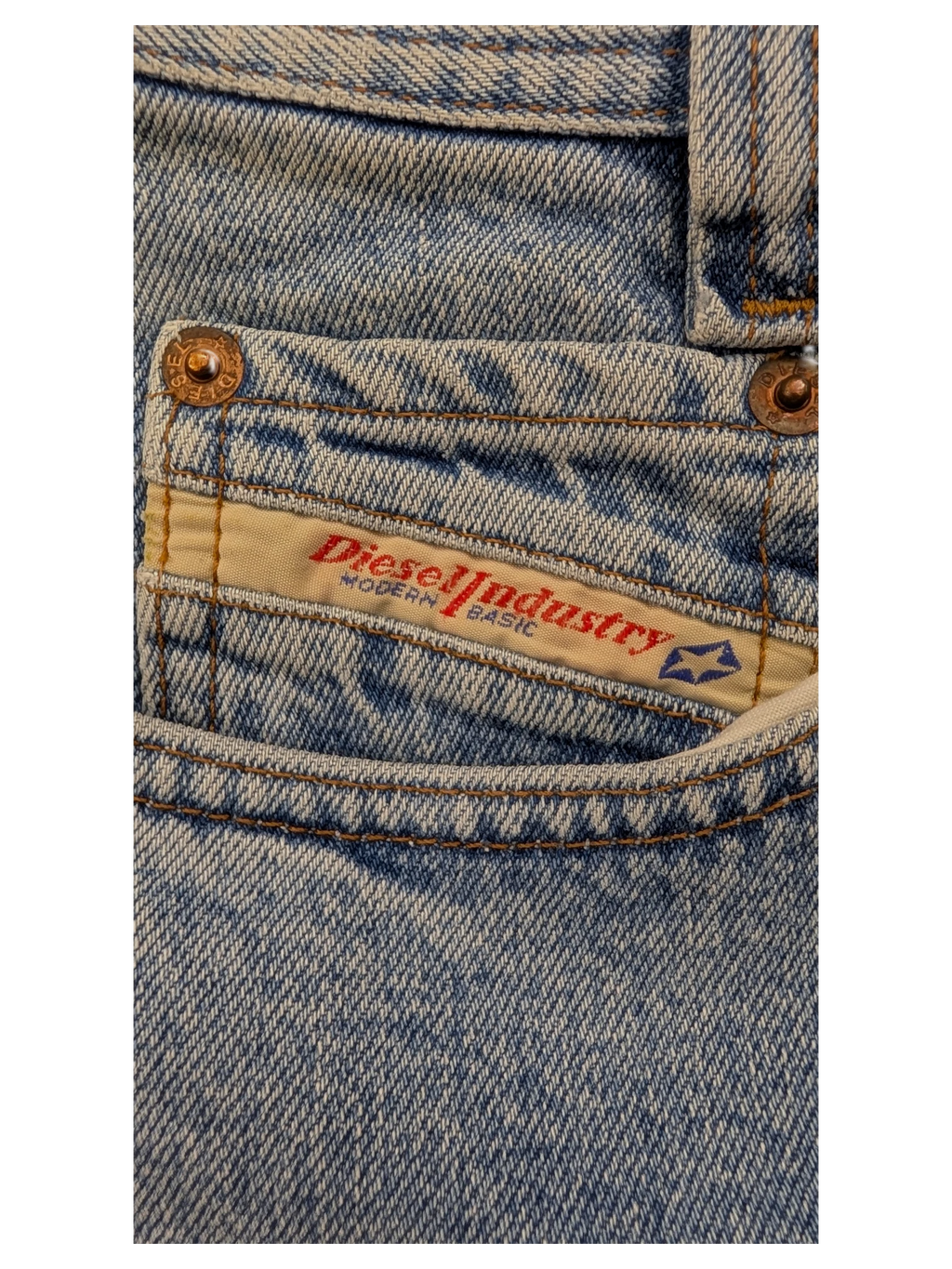JAKE & IPI light wash denim jeans with Diesel Industry Modern Basic label and copper rivets.