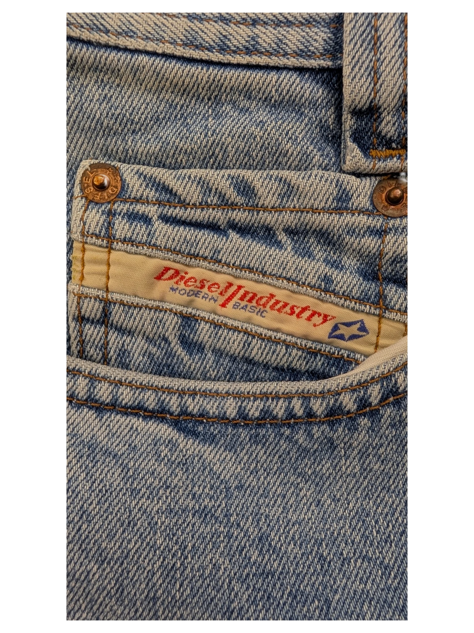 JAKE & IPI light wash denim jeans with Diesel Industry Modern Basic label and copper rivets.