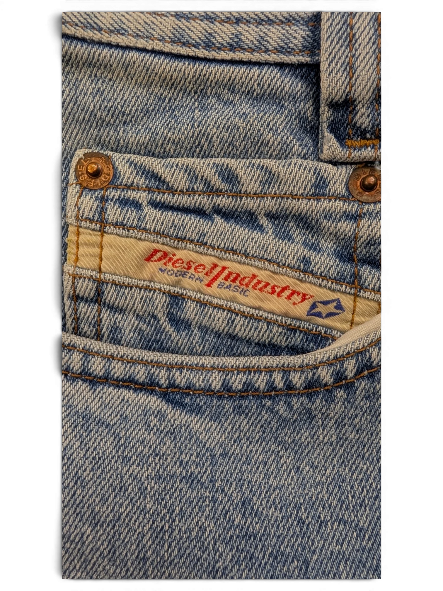 JAKE & IPI light wash denim jeans with Diesel Industry Modern Basic label and copper rivets.