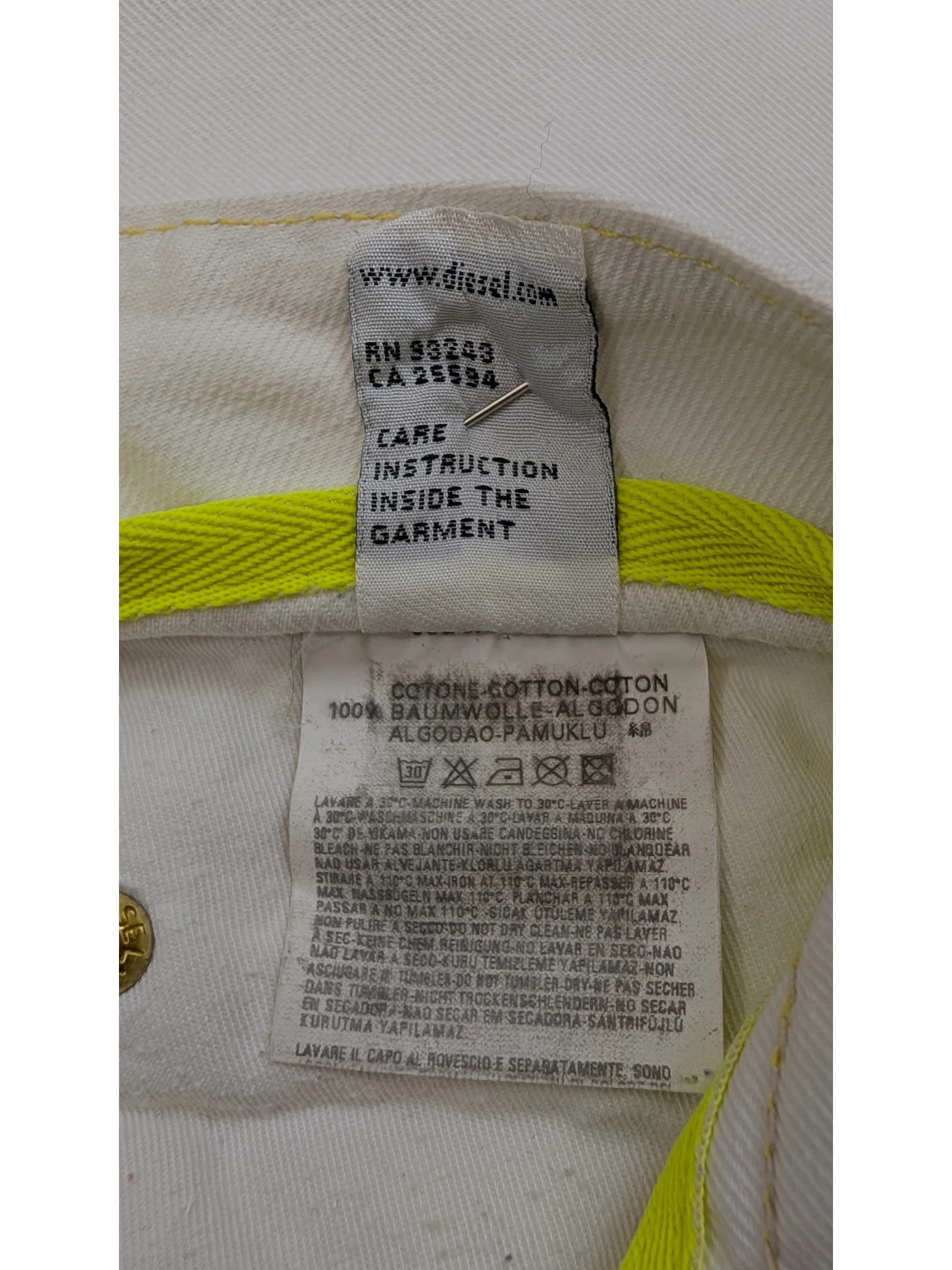 JAKE & IPI Diesel Rabox white cotton jeans with yellow stitching detail and care instructions.