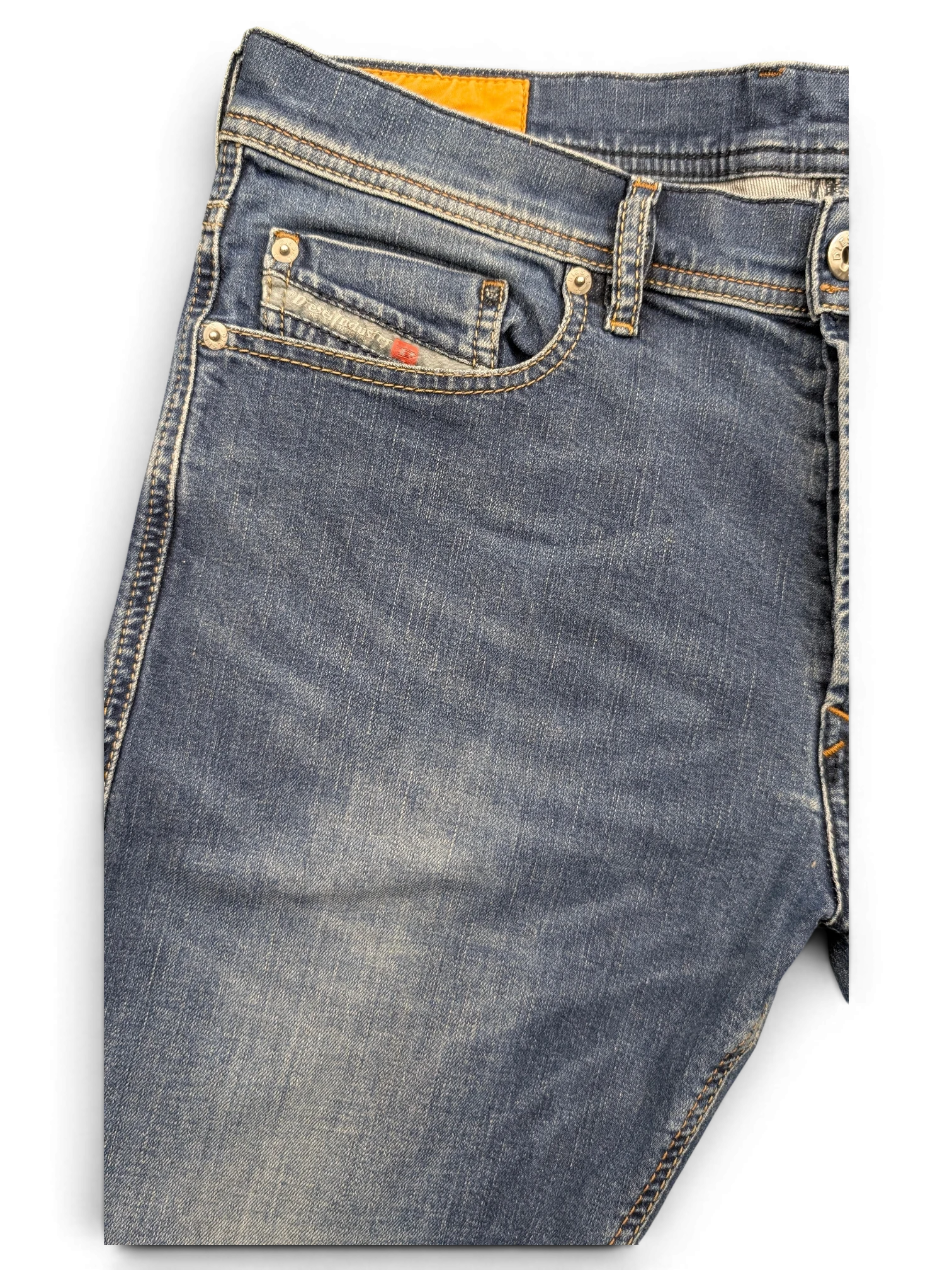 JAKE & IPI Diesel Tepphar blue denim jeans with orange brand tag and red accent on coin pocket.