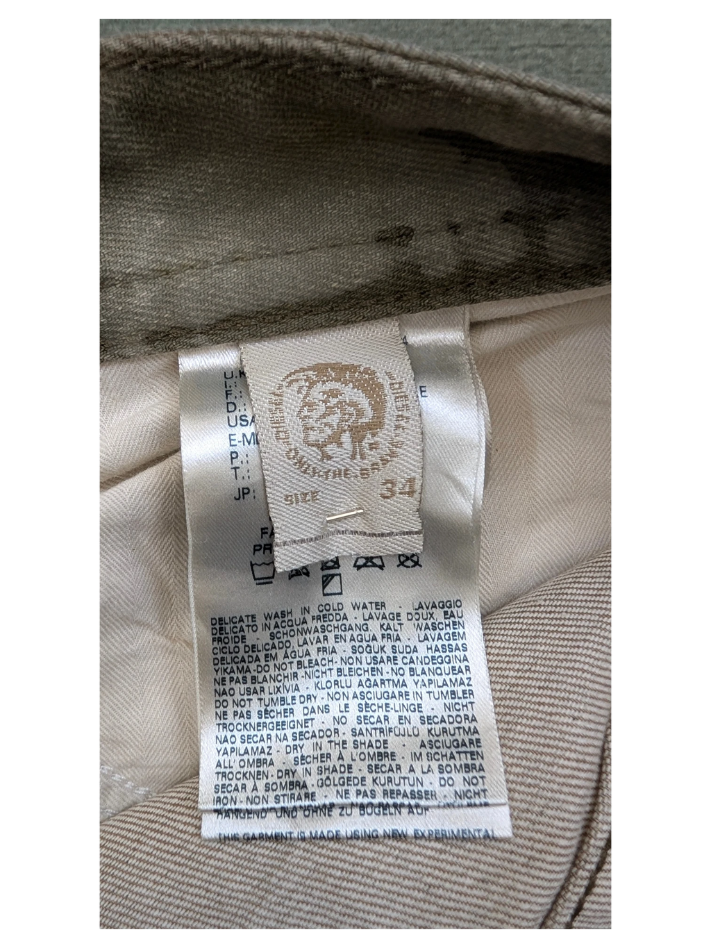 JAKE & IPI Diesel Thavar W34 L32 beige cotton blend jeans with care label detail.