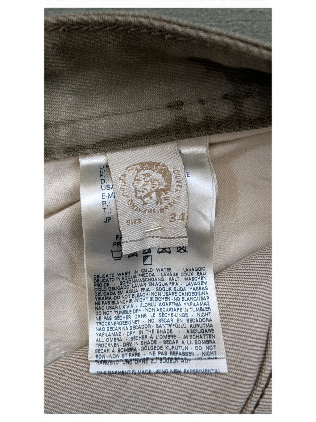JAKE & IPI Diesel Thavar W34 L32 beige cotton blend jeans with care label detail.