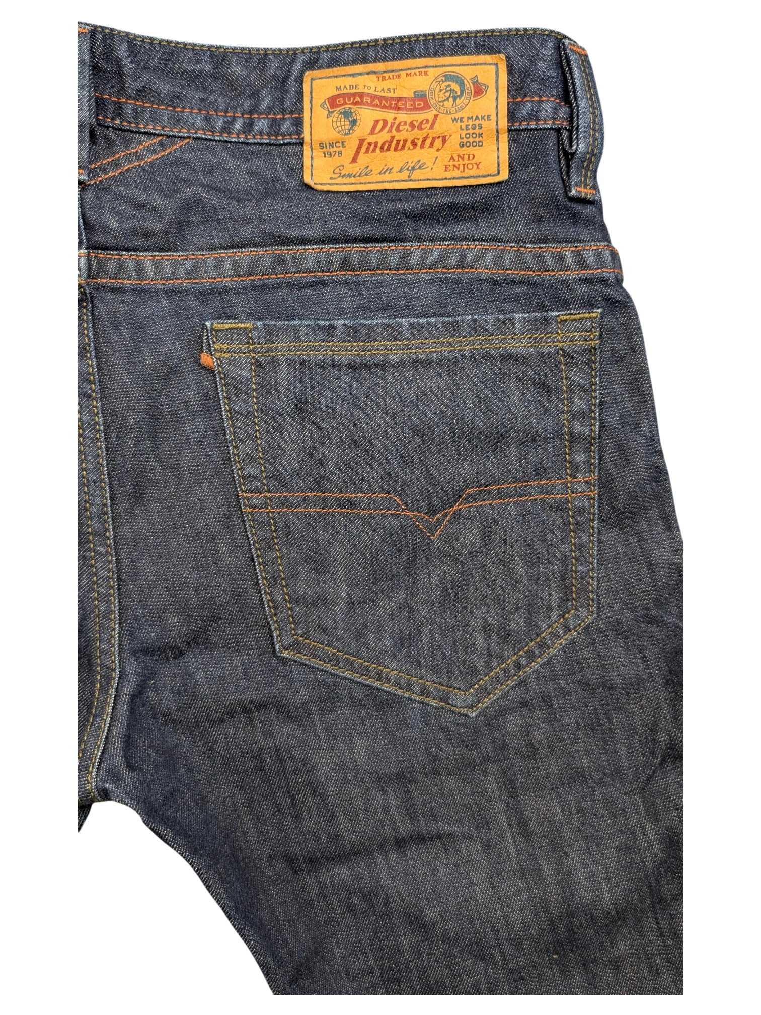 JAKE & IPI Diesel Thavar dark wash denim jeans with orange stitching and signature V-stitch on back pocket.