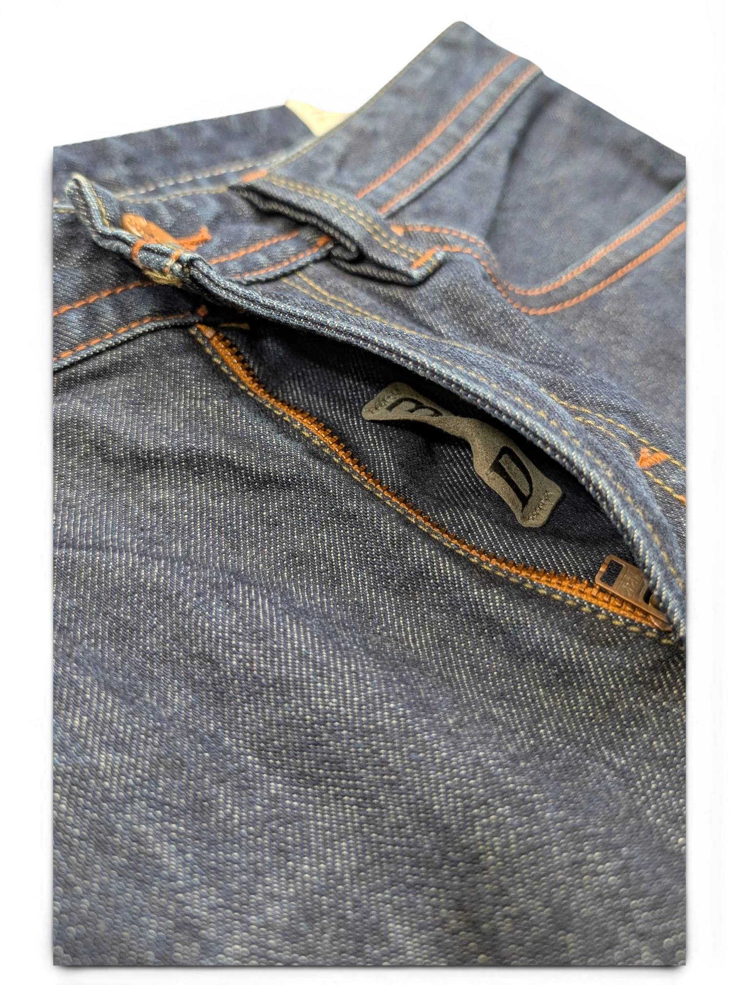 JAKE & IPI dark wash denim jeans with orange stitching and a zip pocket detail.